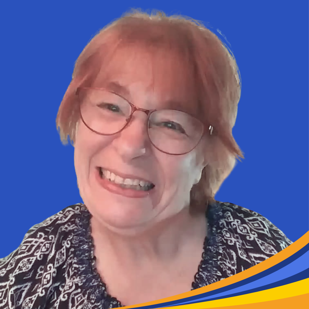 smiling woman with short red hair and brown colored glasses