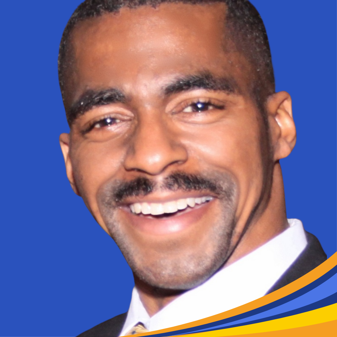 Smiling man with brown eyes, short brown hair and a mustache