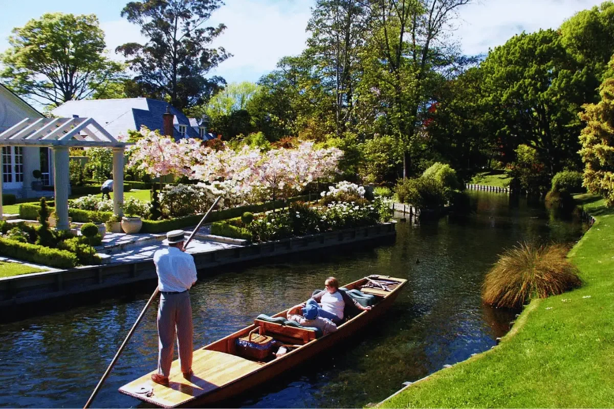 Avon river flowing through Fendalton suburb showing a house for sale