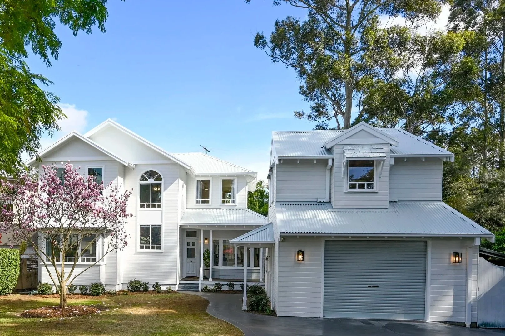 Selling Houses Australia's Oatland exterior is a two storey white-painted Cape Cod vision, with a separate garage and gabled roofline.