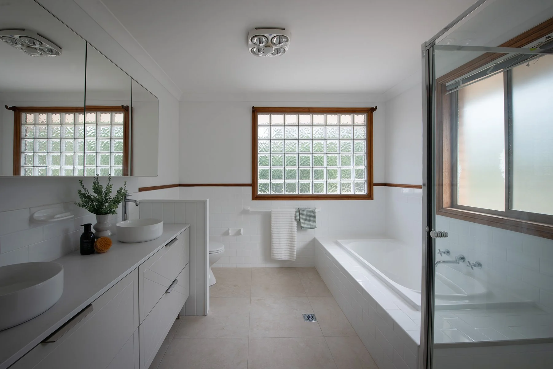 After the renovation, the bathroom is serene, bright and refreshed