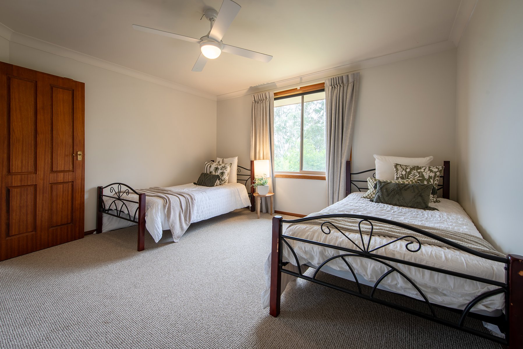 A single bedroom was updated with paint and fresh window dressings.