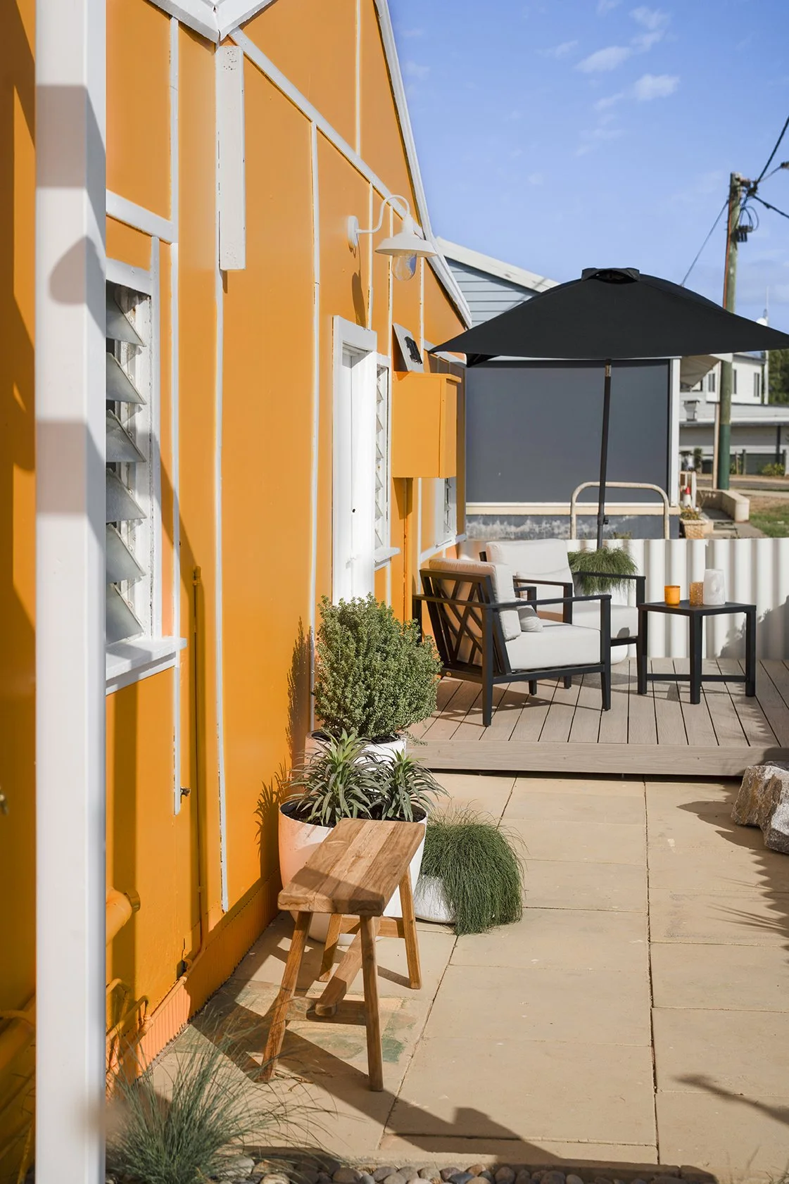 A tangerine exterior and a deck with a view