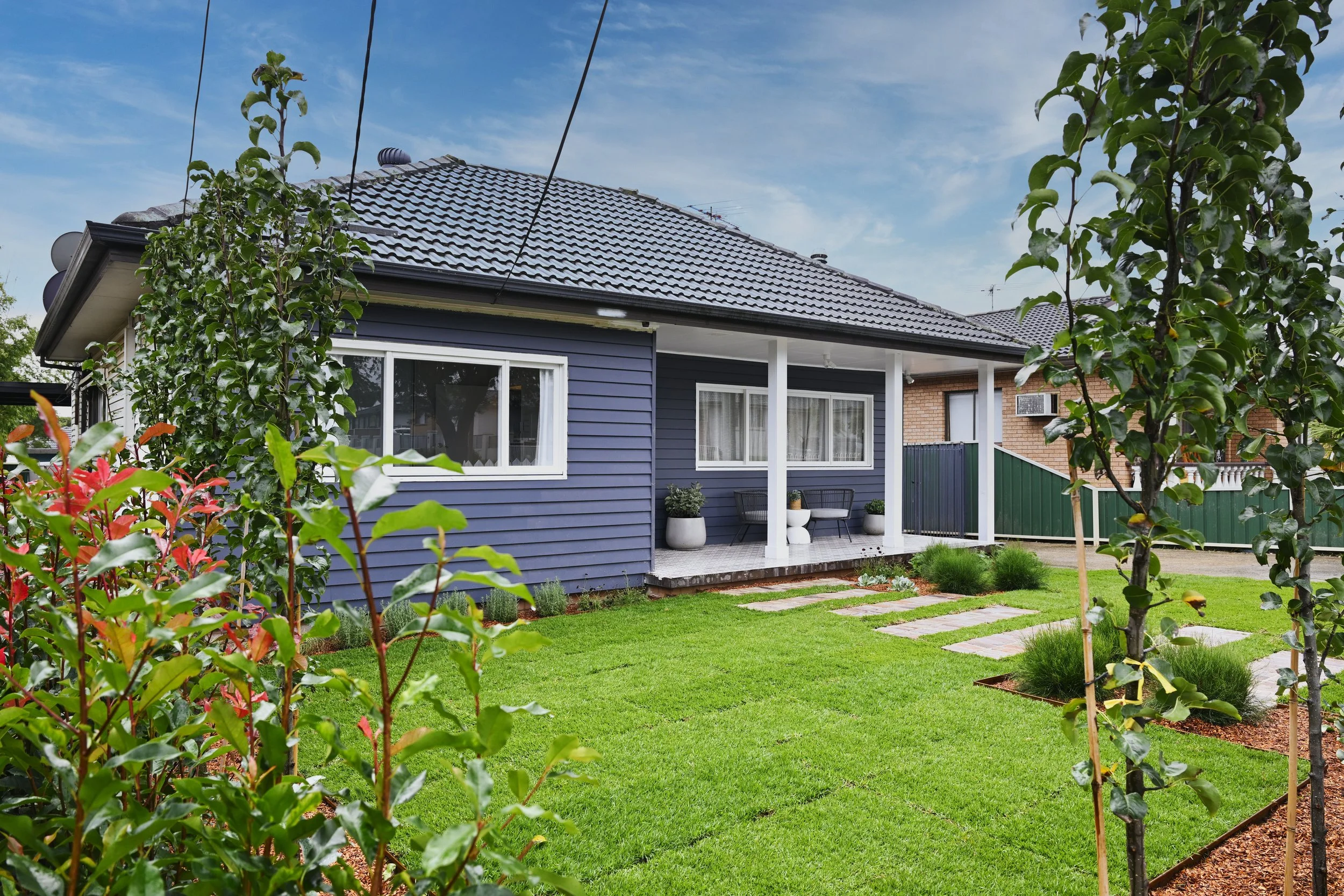 Exterior, after: A cleared, functional front yard with simple steppers and open lawn. (Copy)