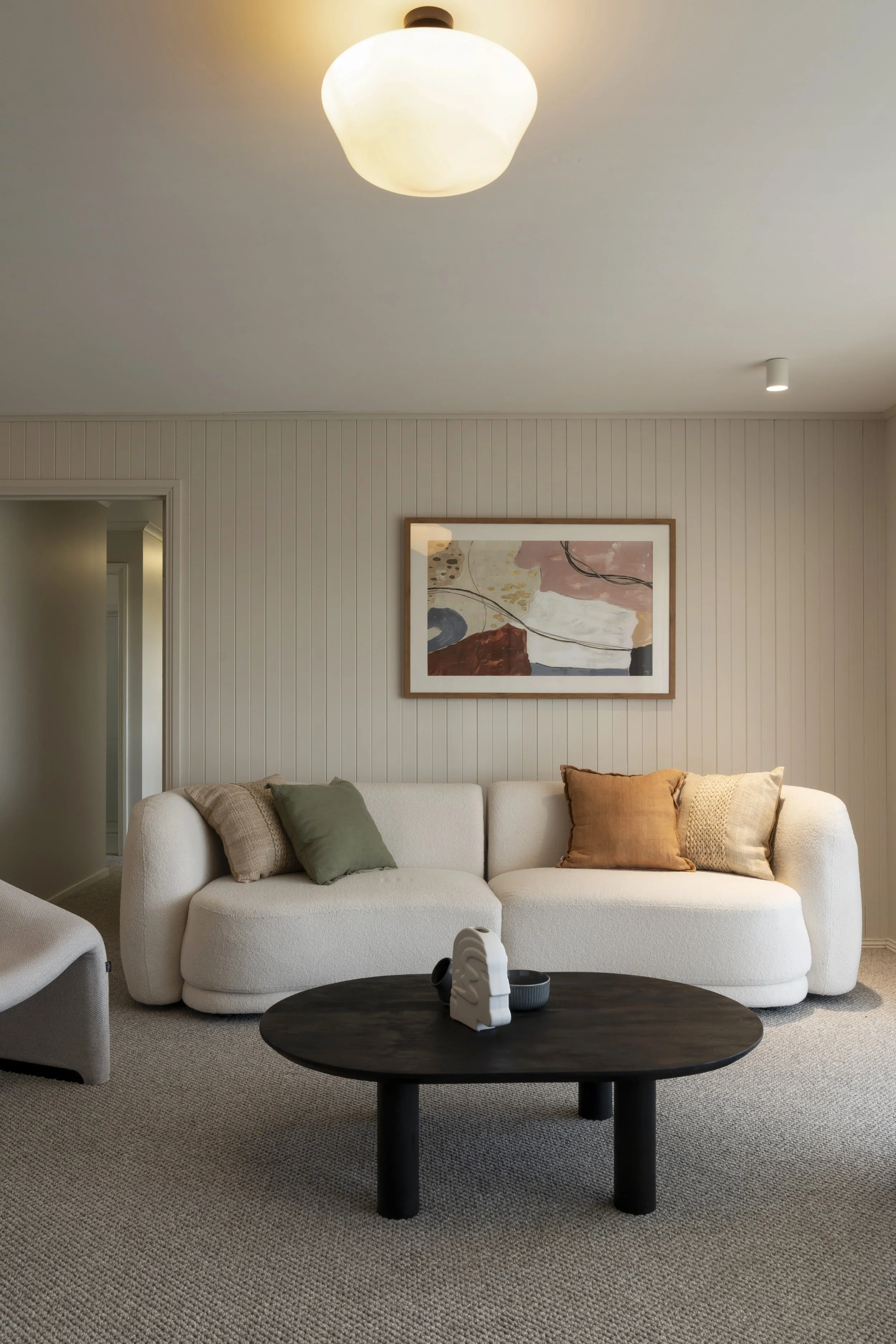 Curvaceous white couch in the seating area in the parents' retreat