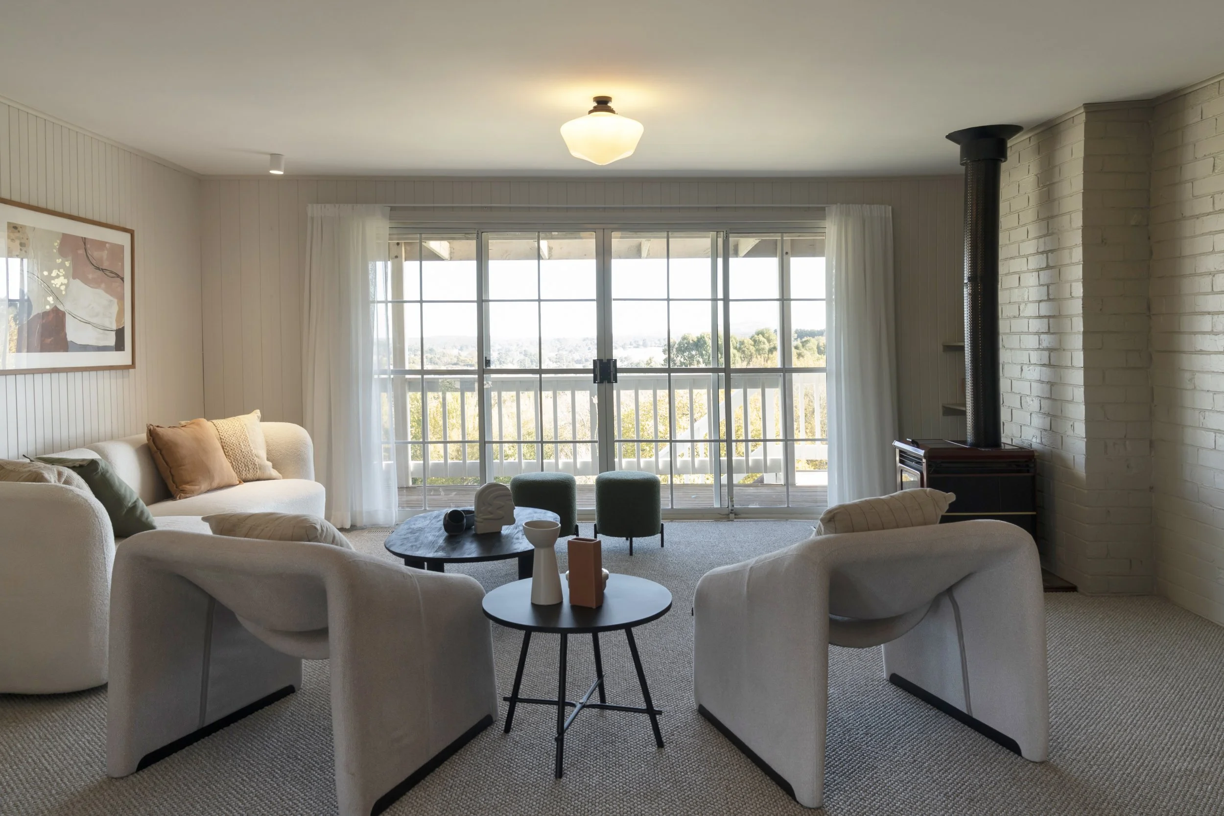 A seating nook with a view to the countryside in Gisborne, Victoria.