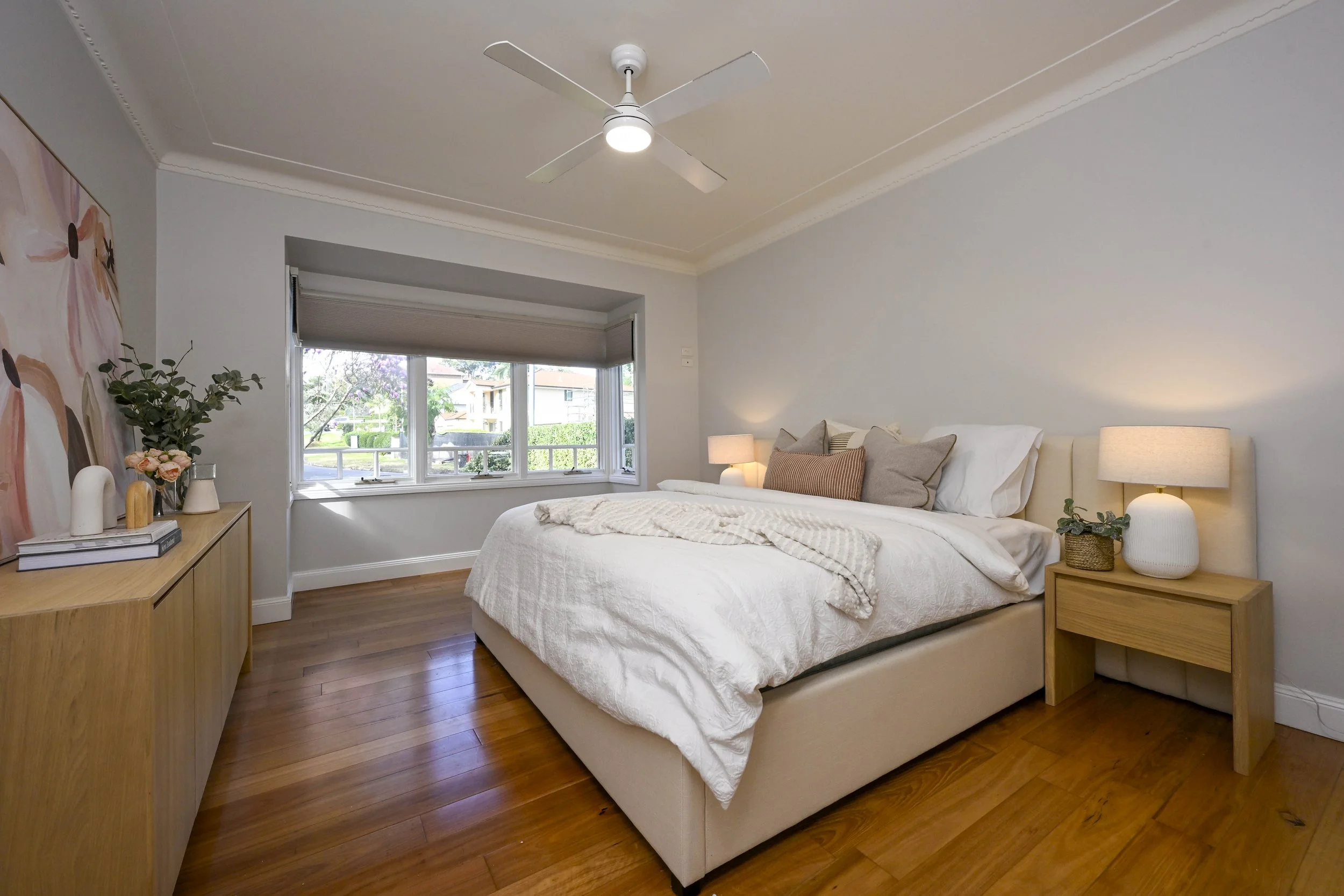 Light‑filled fourth bedroom with carpet flooring, neutral walls and large window in Oaklands NSW home.