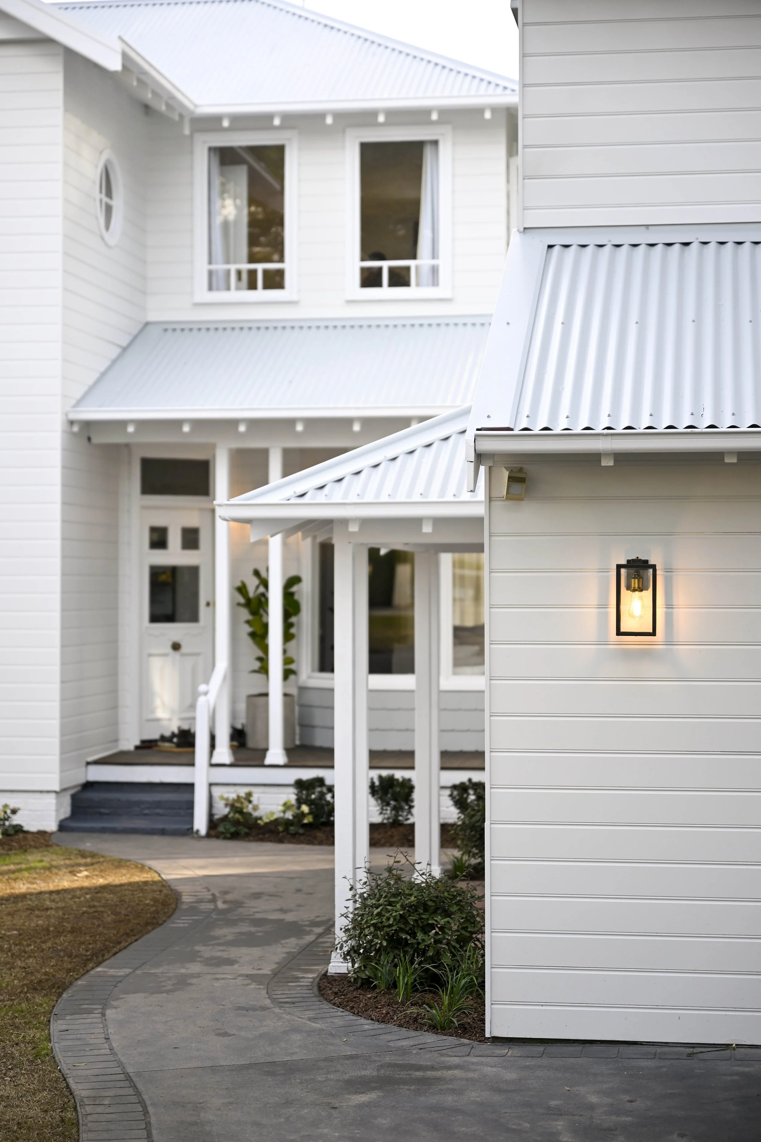Characterful timber details define this Hamptons style exterior facade, including a balcony, gable and trims. 