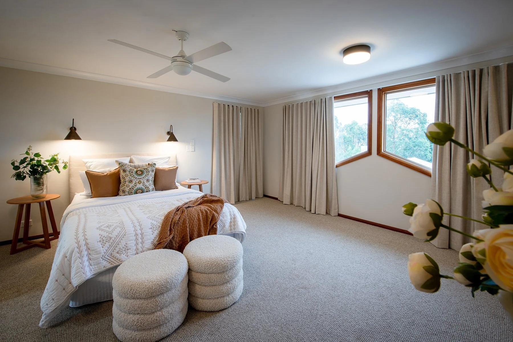 Restyled master bedroom with soft neutrals, sheers and coordinated furniture.