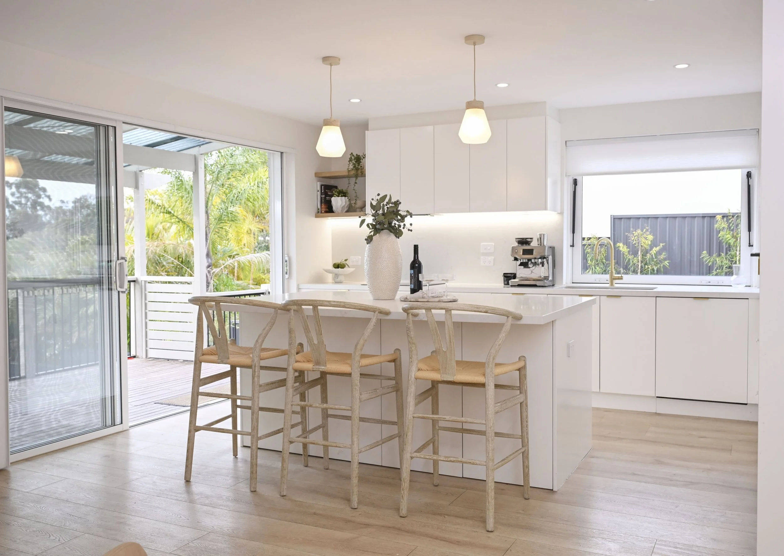 Bright kitchen with Lexicon pendants, light-filtering blinds and unified styling