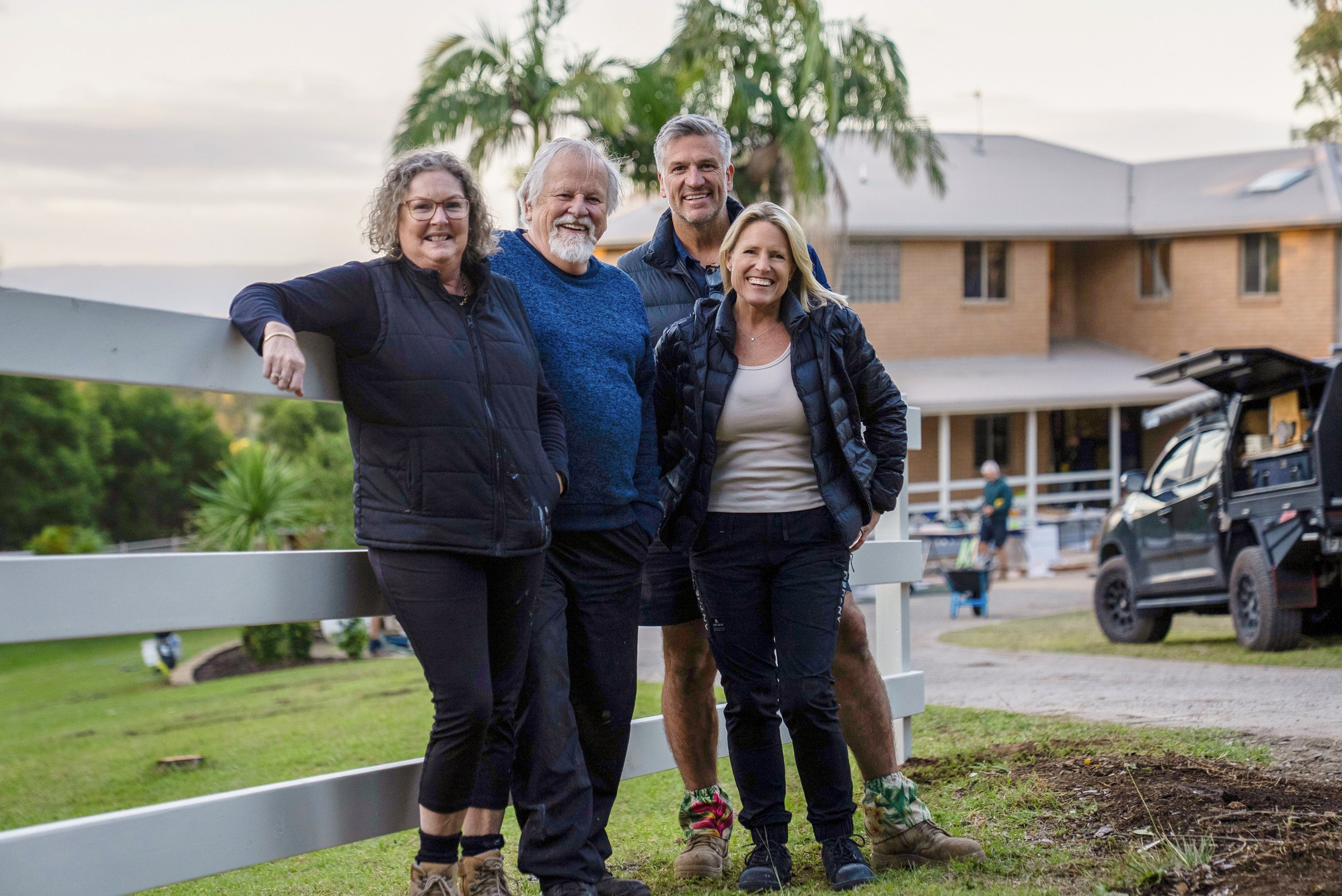 Robin and Rob smile happily outside their home with Wendy Moore and Dennis Scott.