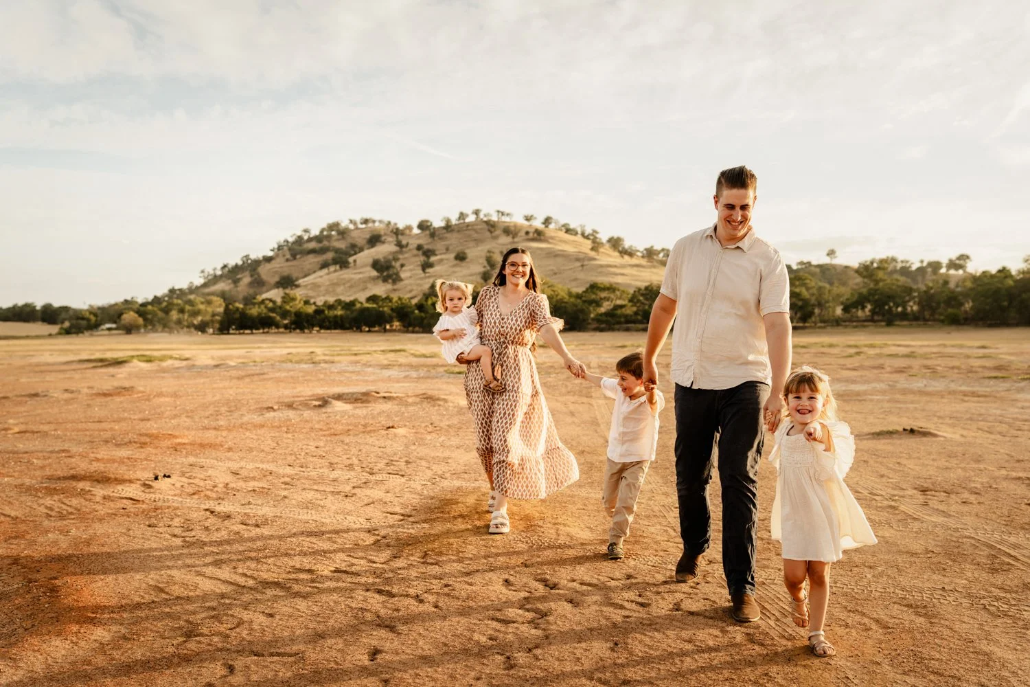 family walks together at sunset
