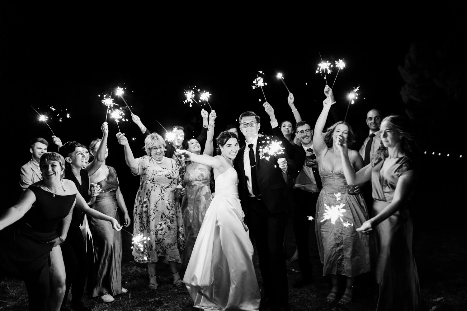 newly wedded couple surrounded by sparklers