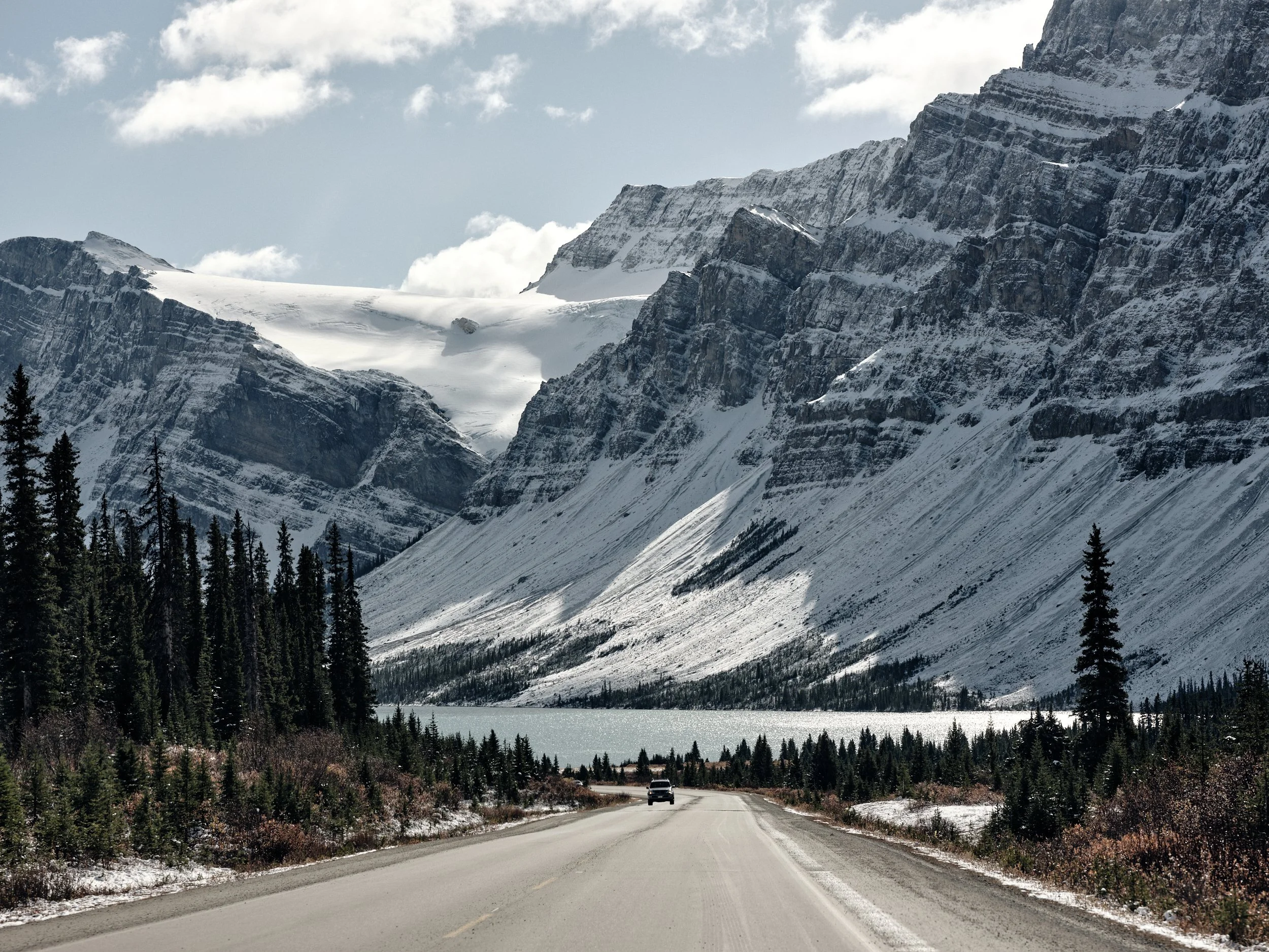 A highway with the Rocky Mountains in the background.