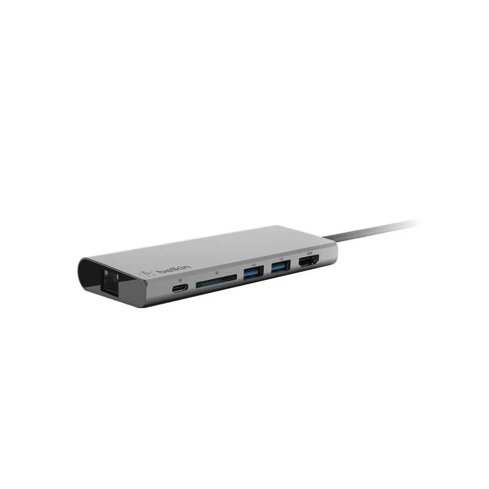 A silver docking station with multiple ports, including USB-A, USB-C, HDMI, and SD card slots, connected to a cable.
