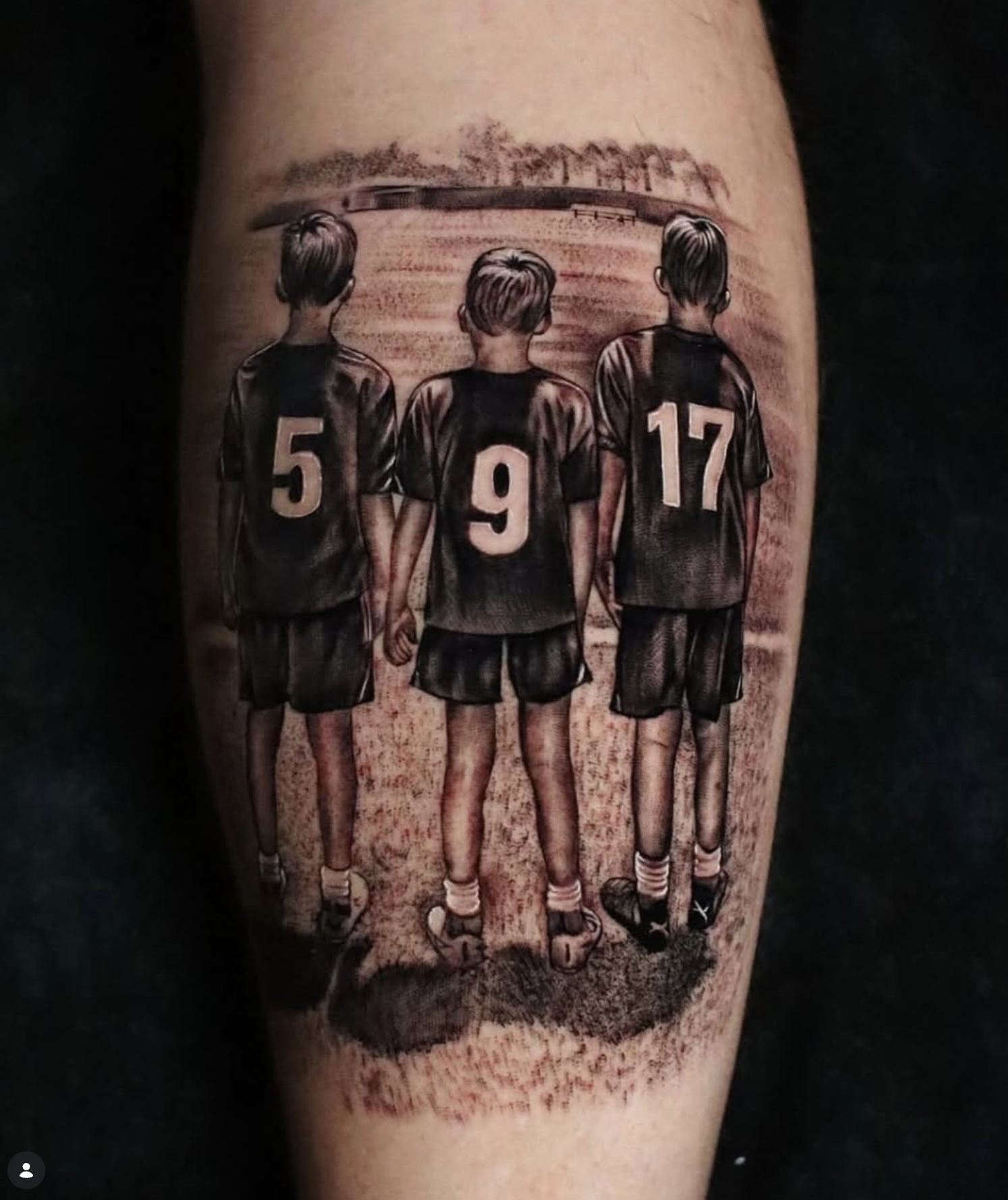 Tattoo of three soccer players standing with their backs turned, wearing jerseys with the numbers 5, 9, and 17 on a person's arm.