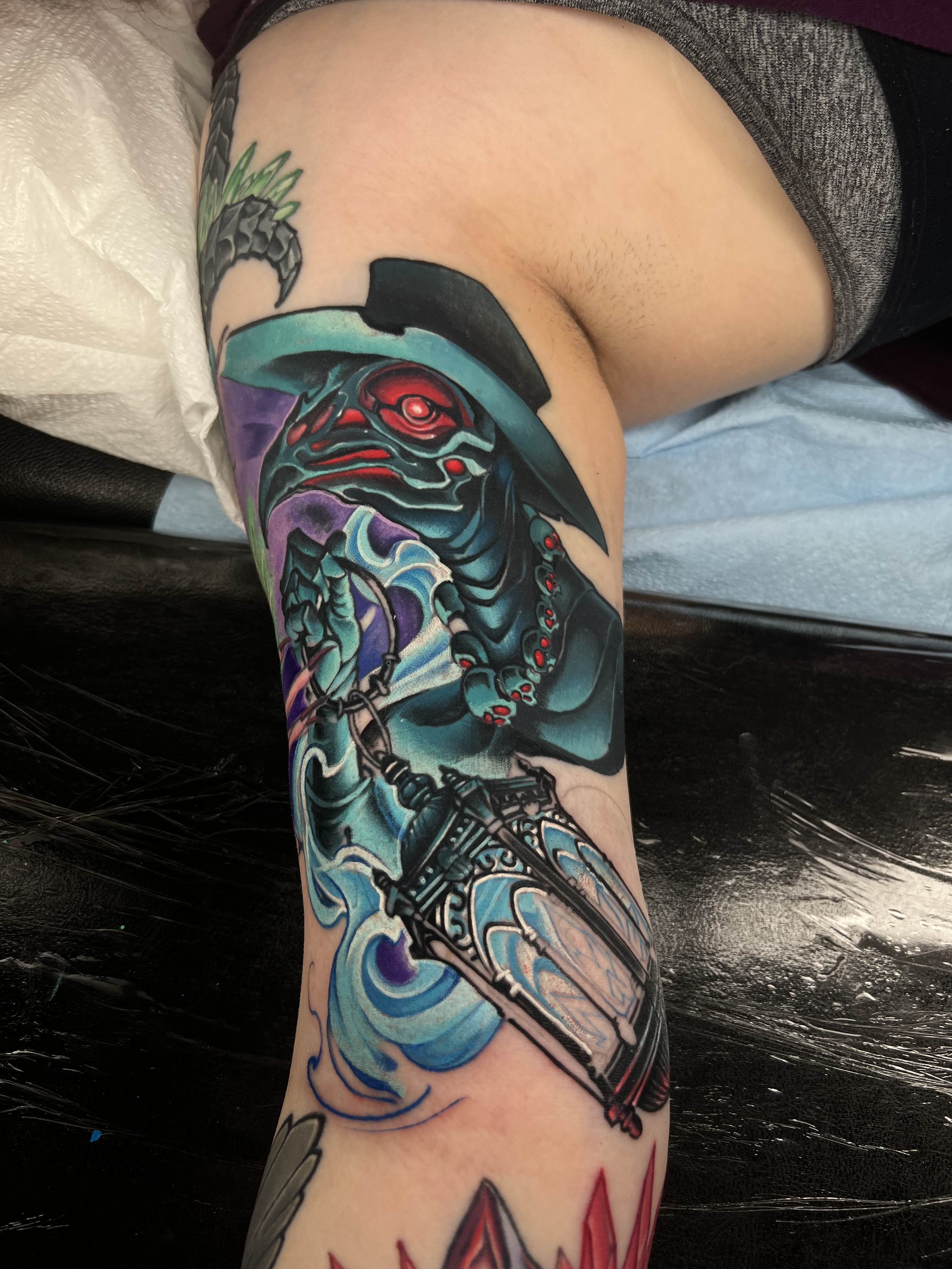 Colorful tattoo of a plague doctor on a person's arm.