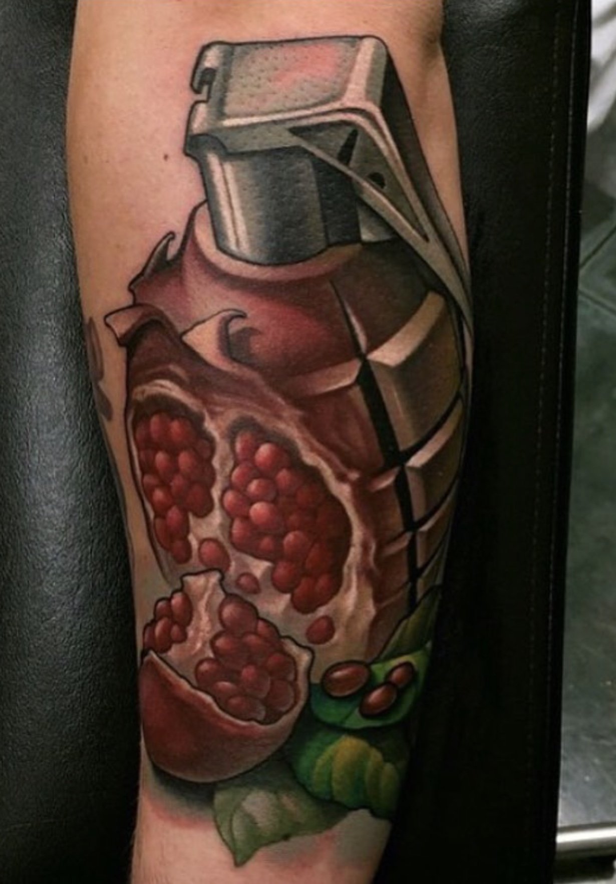 Tattoo of a pepper grinder and a pomegranate, with a green leaf at the bottom.