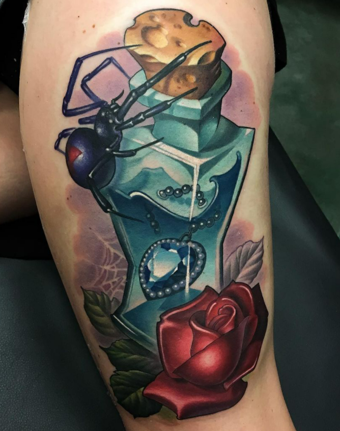 Tattoo of an open perfume bottle with a red rose at the base, a spider crawling on the bottle, a chain and a pendant inside the bottle, and a cookie on top of the bottle's cap.