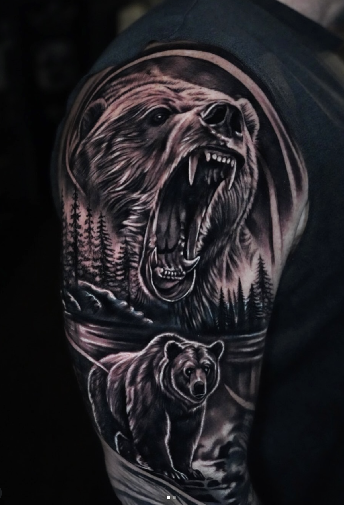 Tattoo of a roaring bear with a forest and mountain background, and a bear cub at the bottom.