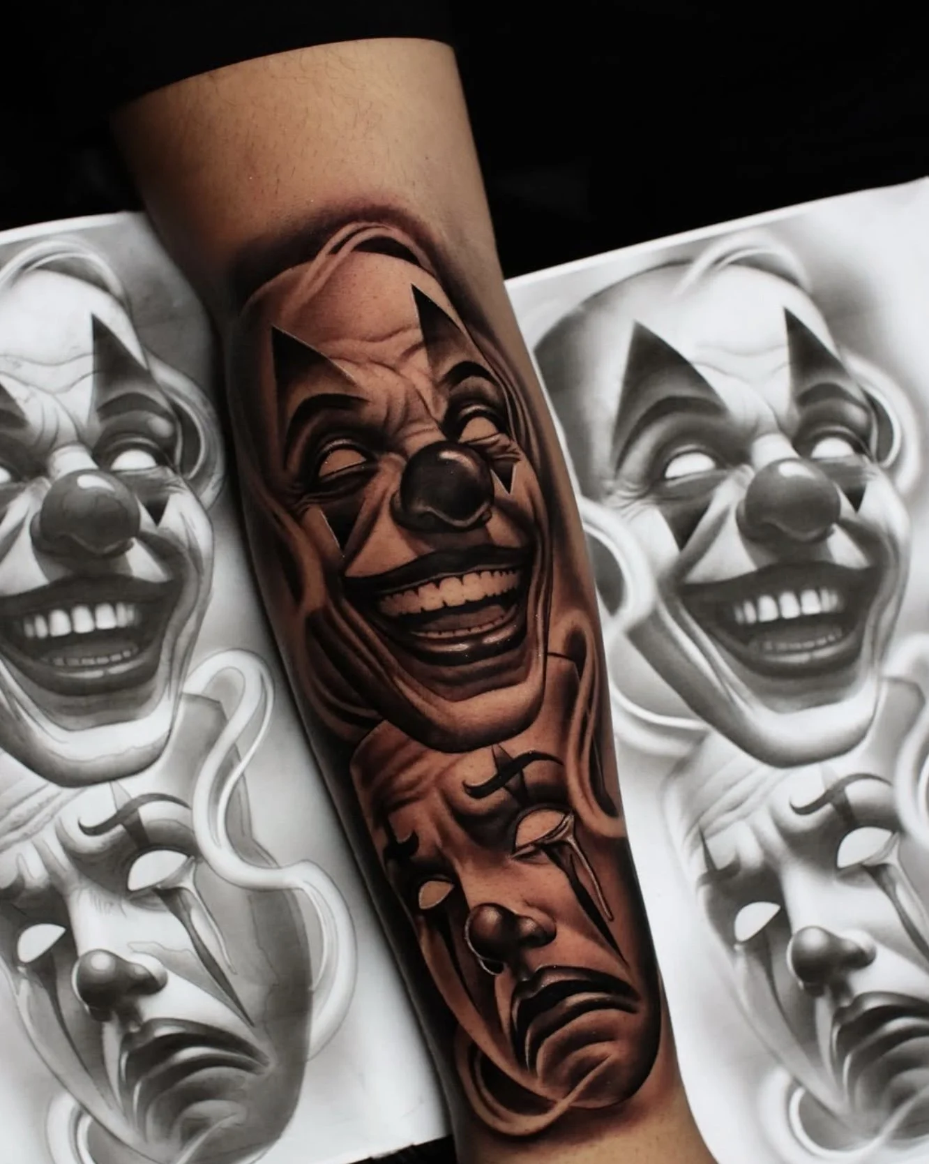 Close-up of a tattoo of a clown's face with exaggerated features and a big smile, placed on a person's forearm, with multiple copies of the same clown face in the background.