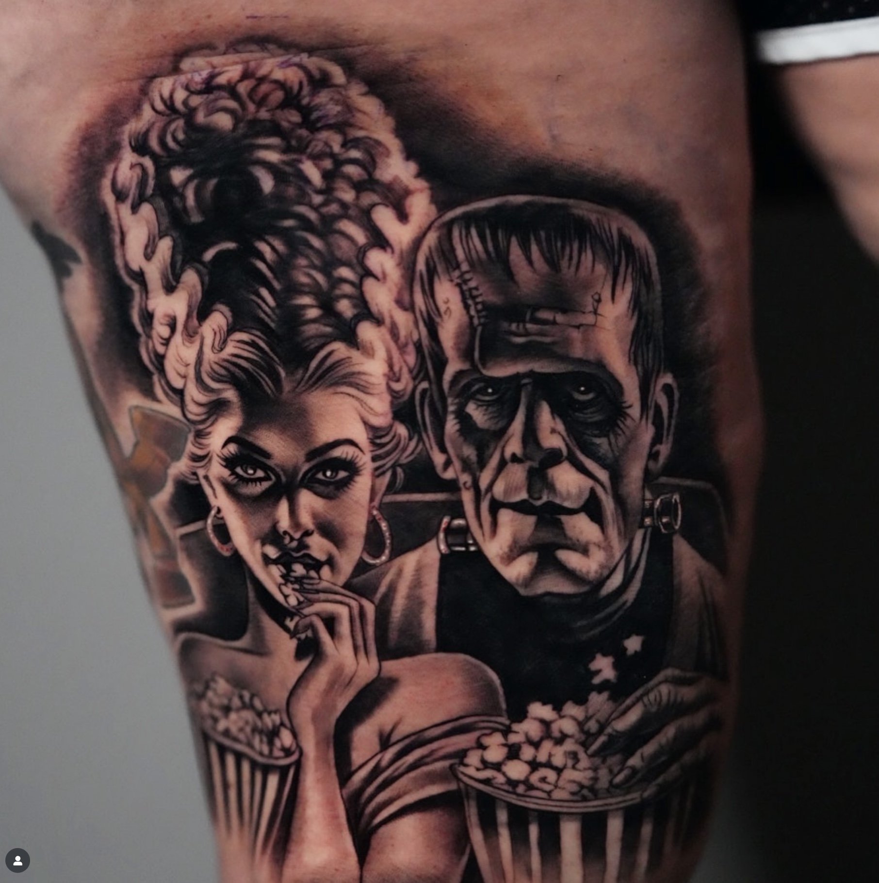 Black and gray tattoo of a woman with elaborate hair and a man with a stern face, both holding bowls of popcorn.