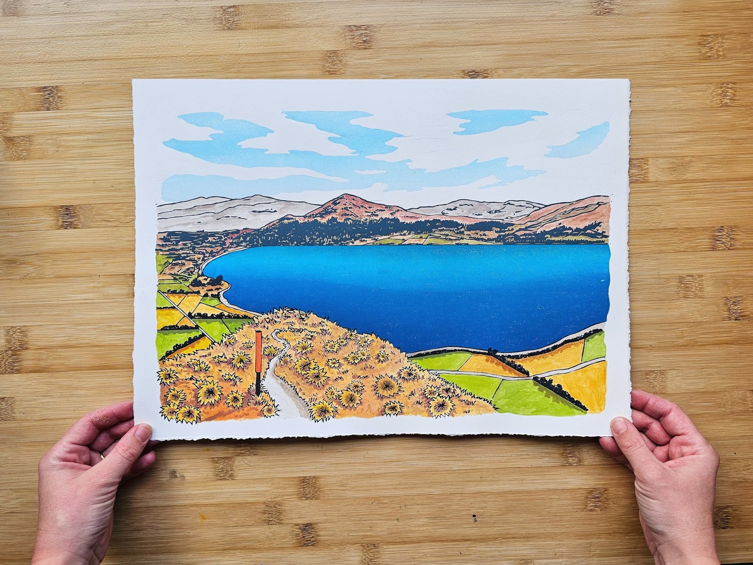 A colourful original hand-painted multi-block linocut artwork of Lake Hāwea.