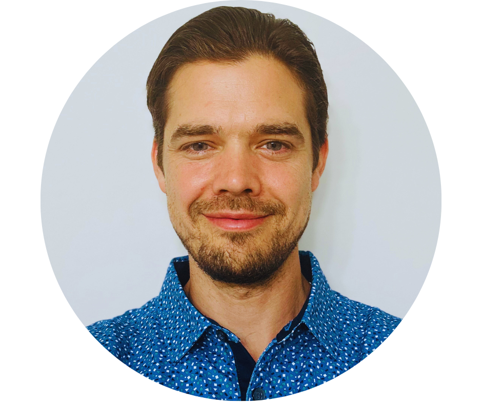 Portrait of a man in a blue patterned shirt.