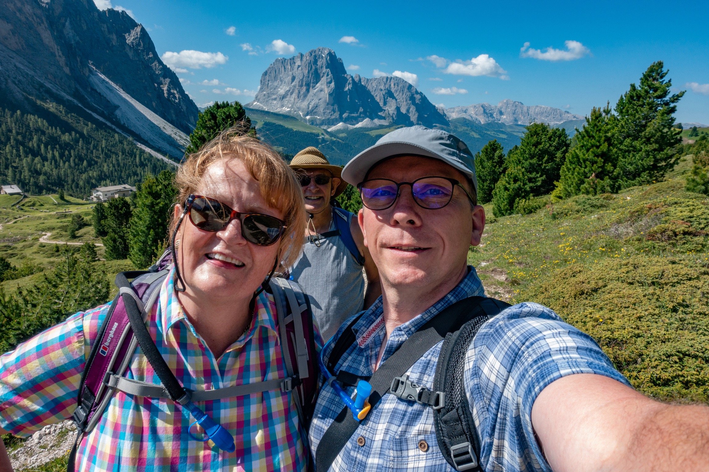 Sarah and Ben, with our friend Rob and the Sasso Lungo in the distance. Santa Cristina, Val Gardena, Italy.