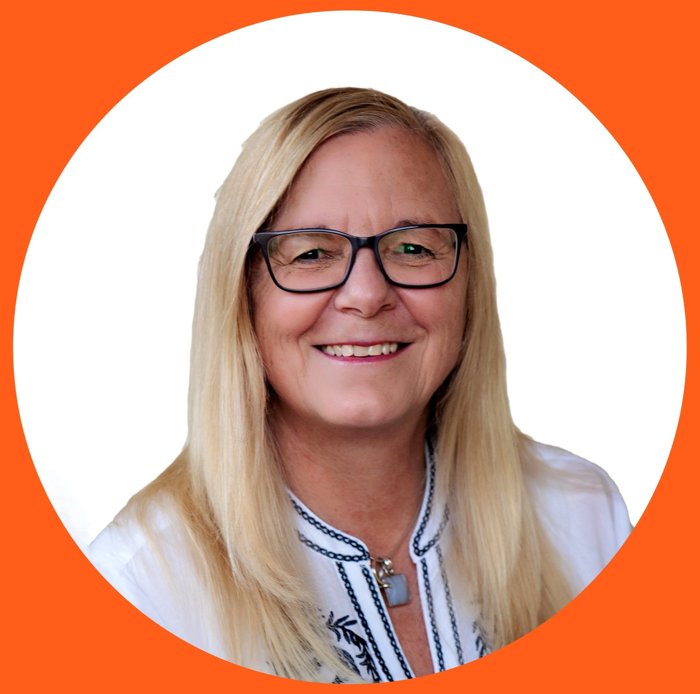 A woman with blonde hair wearing glasses and a white blouse with black embroidery, smiling, against a white background with an orange border.