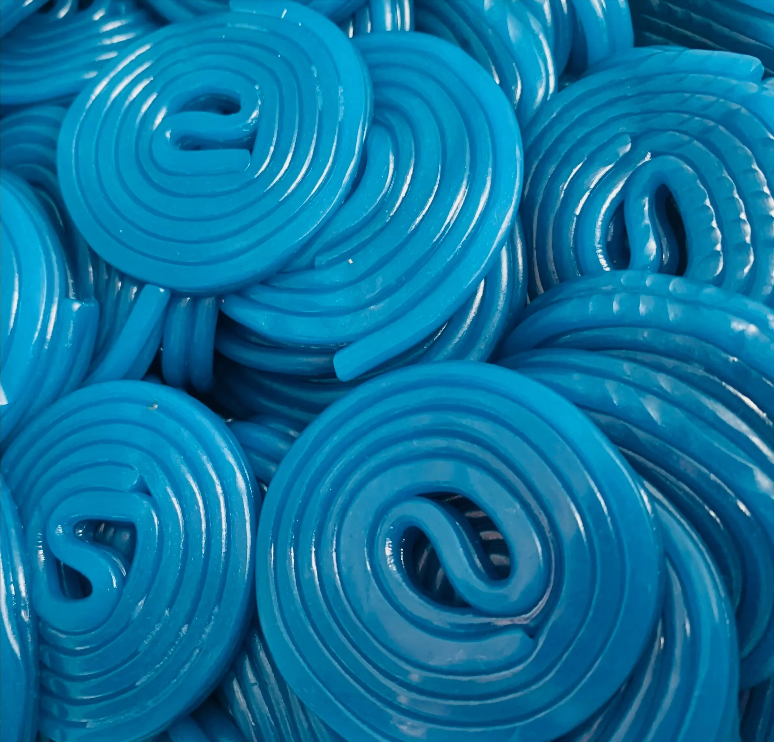 Close-up photo of coiled blue gummy candies.