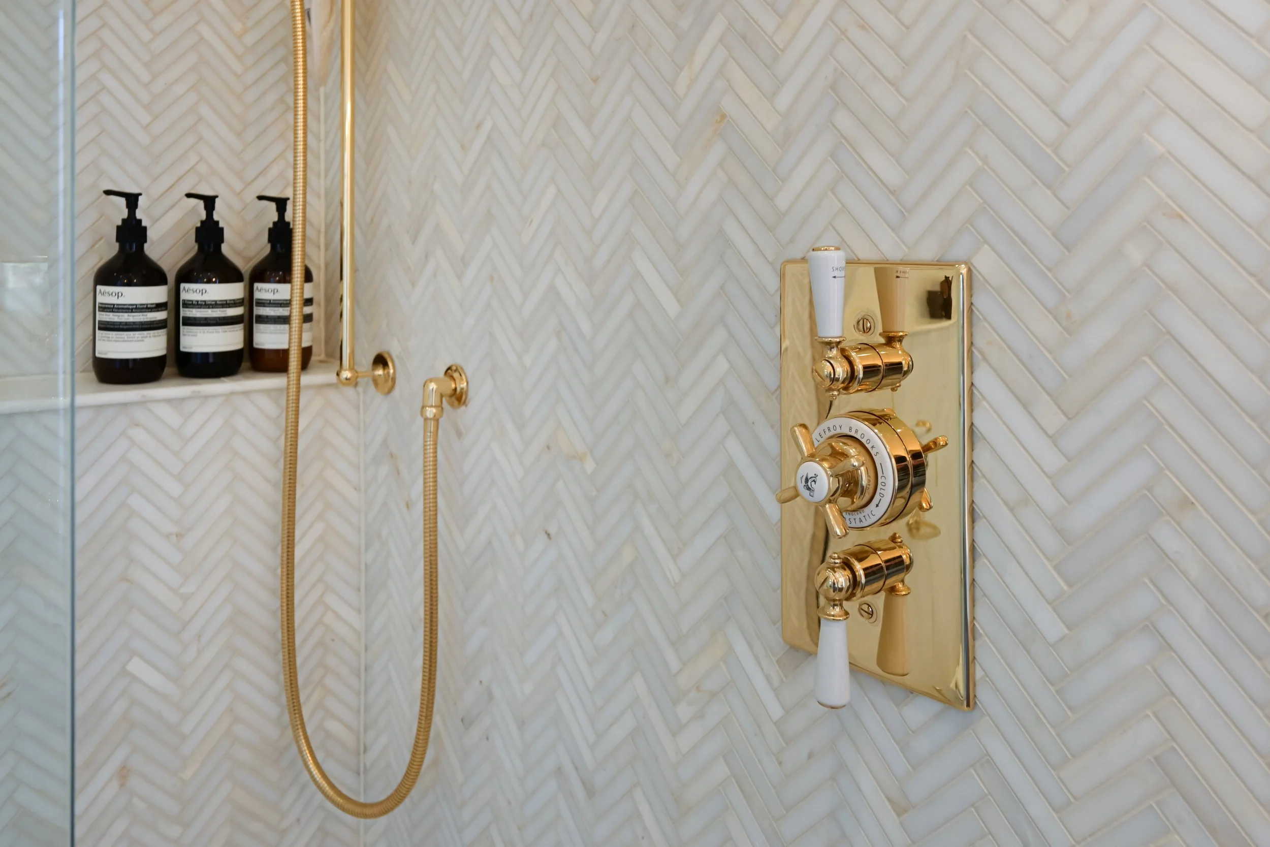 Traditional Lefroy Brooks brassware blends beautifully with the contemporary tiling