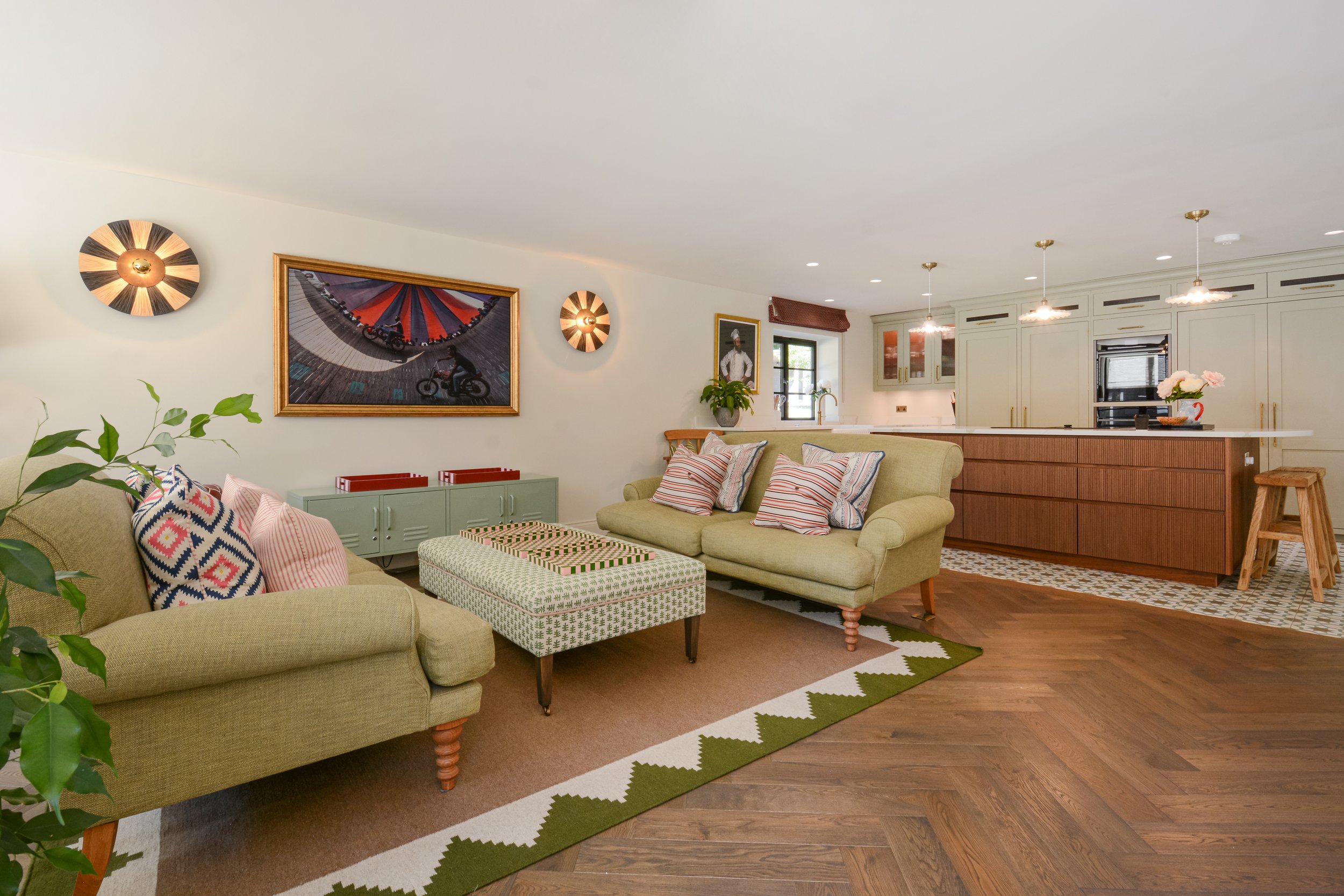 Wood flooring matches the island while the tiled area zones the kitchen and is easy to clean