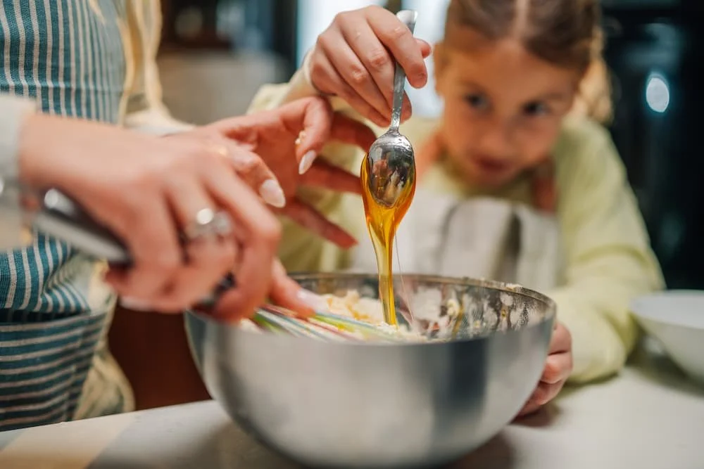 pouring honey into batter mixture
