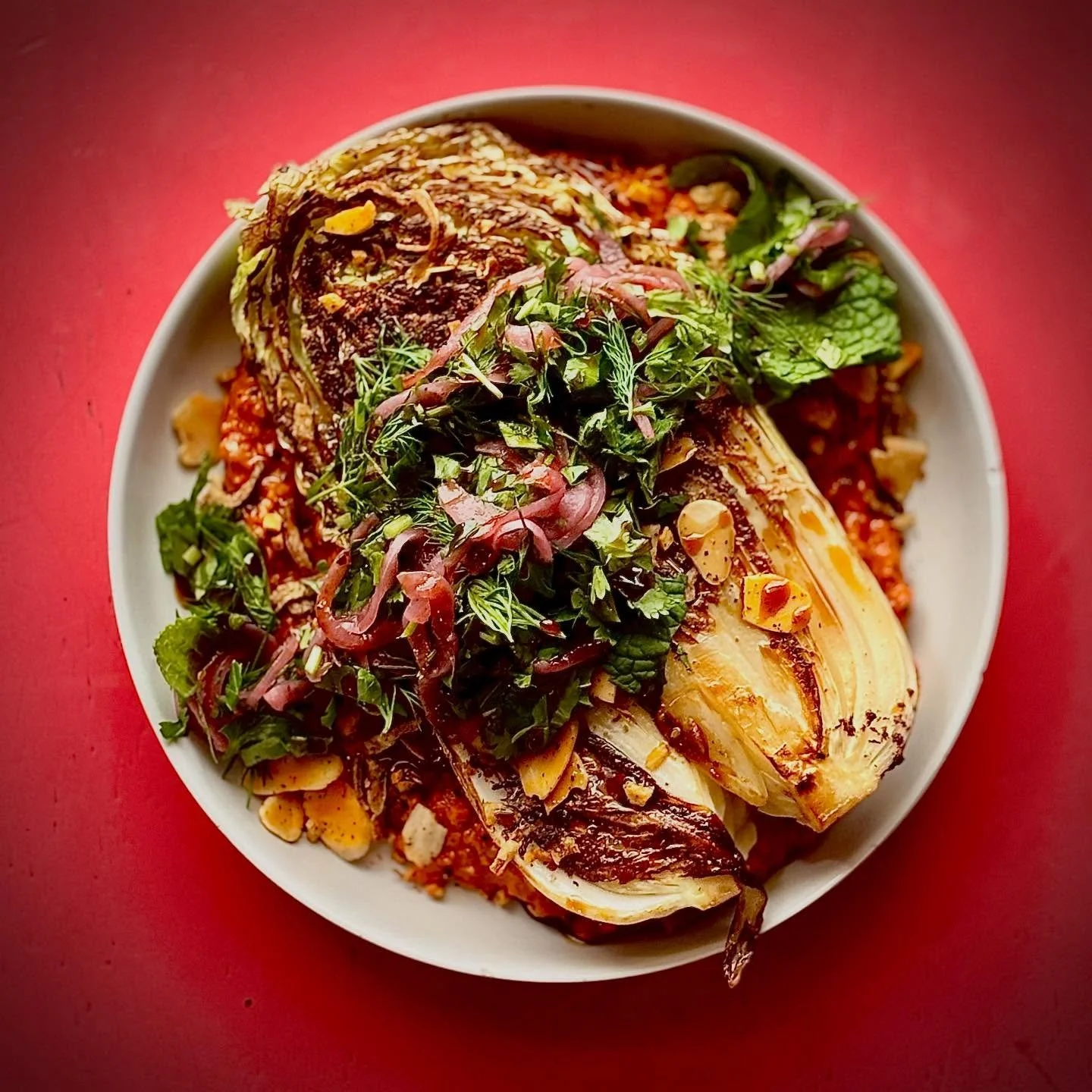 GRIDDLED NAPA CABBAGE with muhammara, almond, pomegranate molasses, sumac onion and herbs