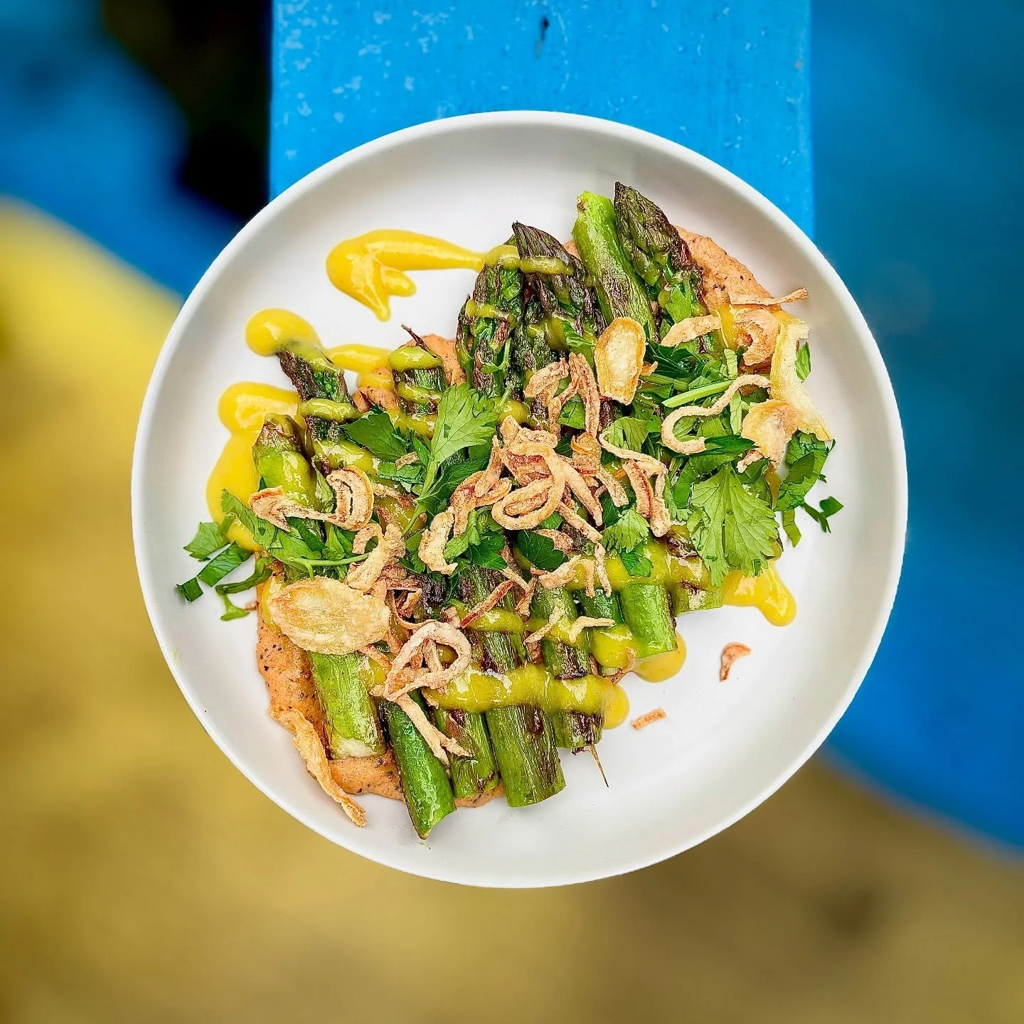 New new. GRIDDLED ASPARAGUS black harissa cashew cream, pickled golden raisin, fried shallots. Vegan!