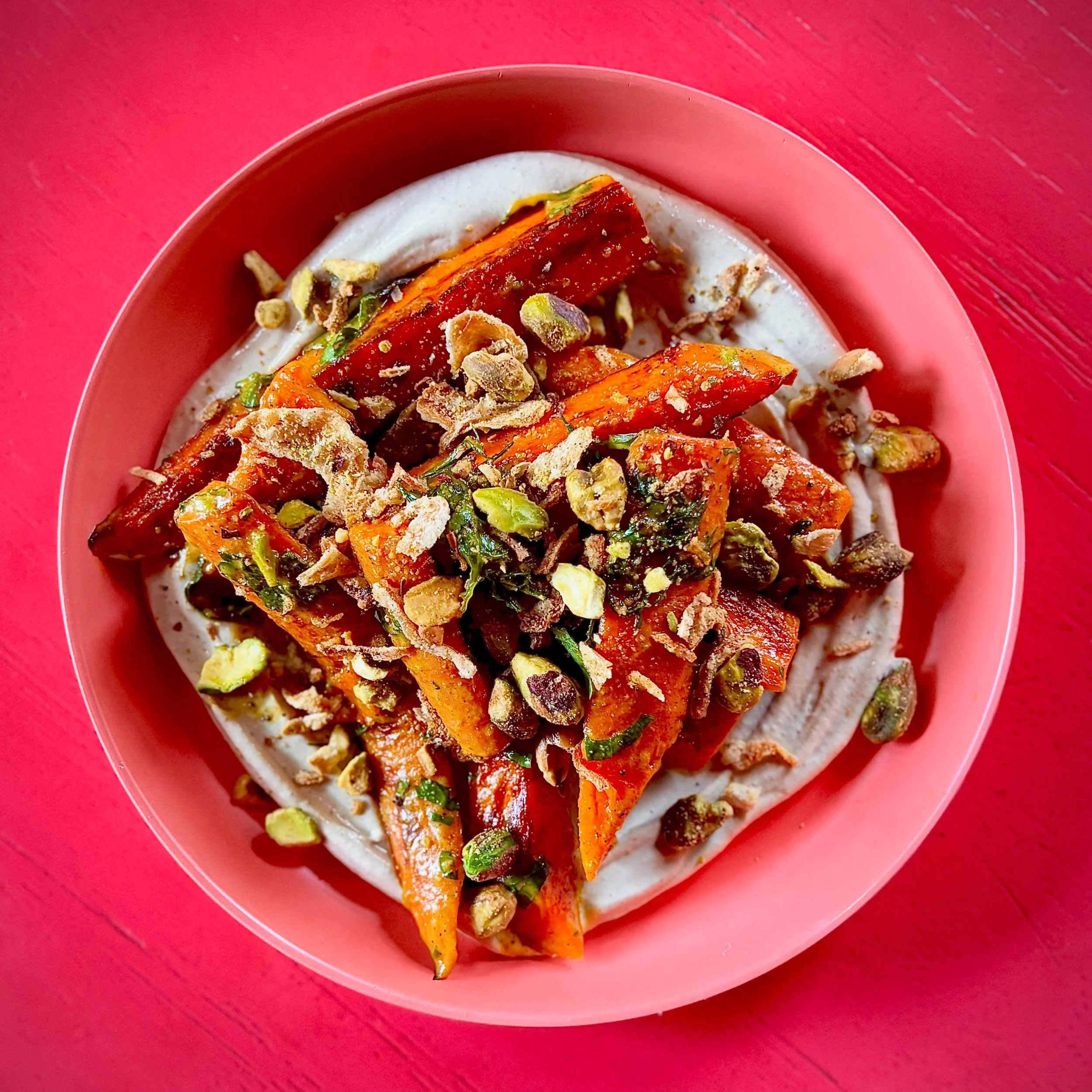 New to the menu! GRIDDLED CARROTS bathed in amba, hawaij and fresh herbs atop pistachio tahini with pistachio crumble. 💫🤩💫