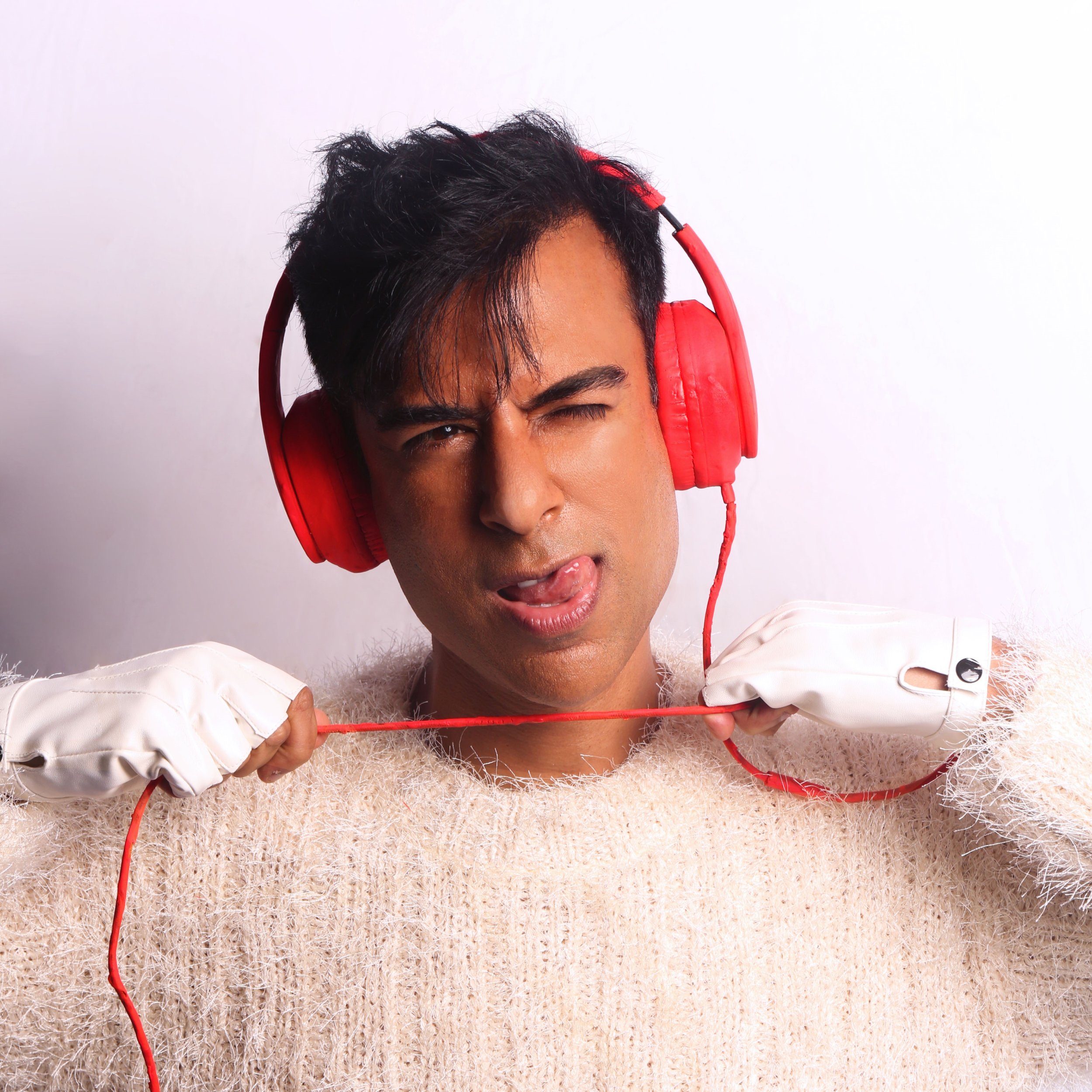 man with red headphones pulling on cord