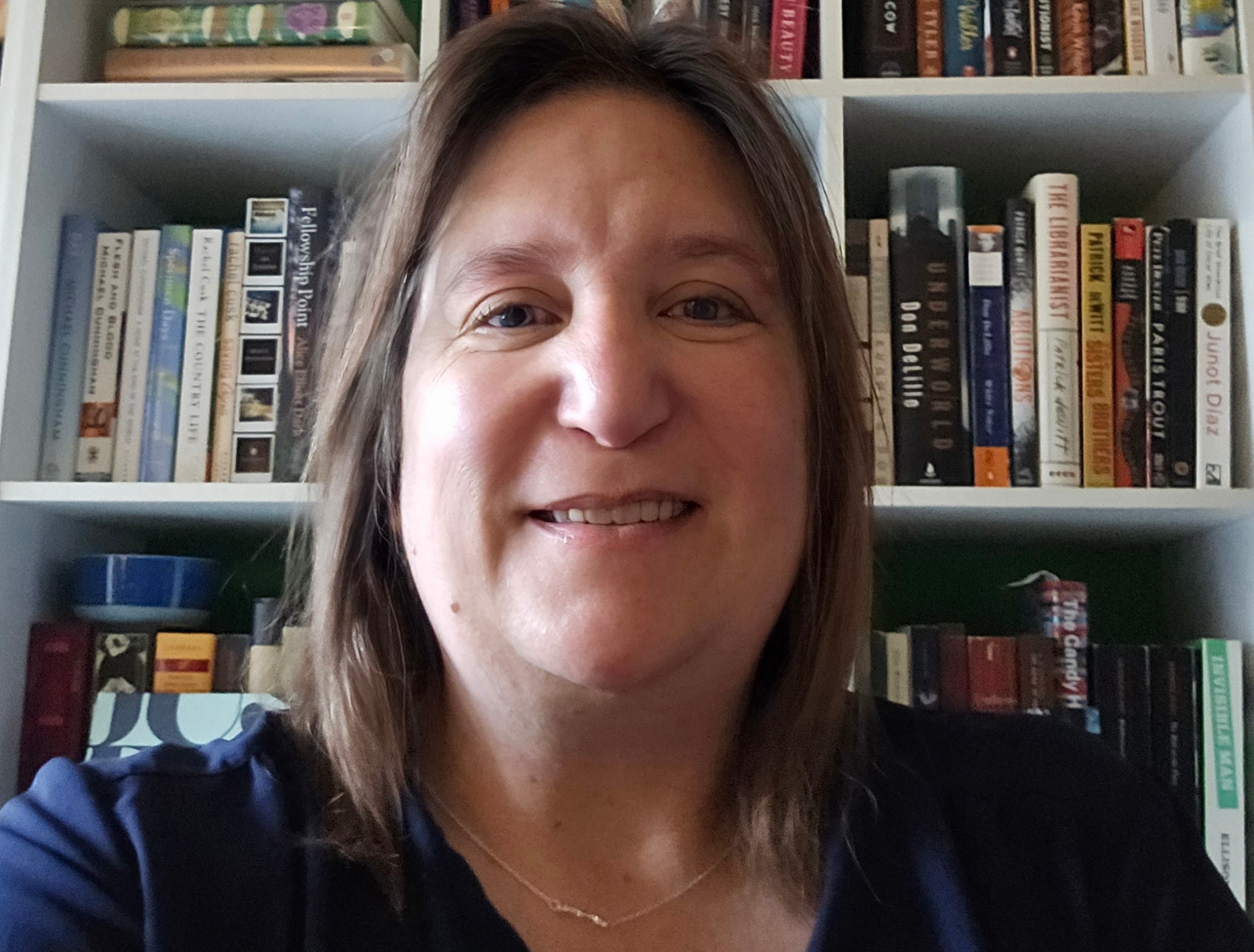 woman in front of bookshelf