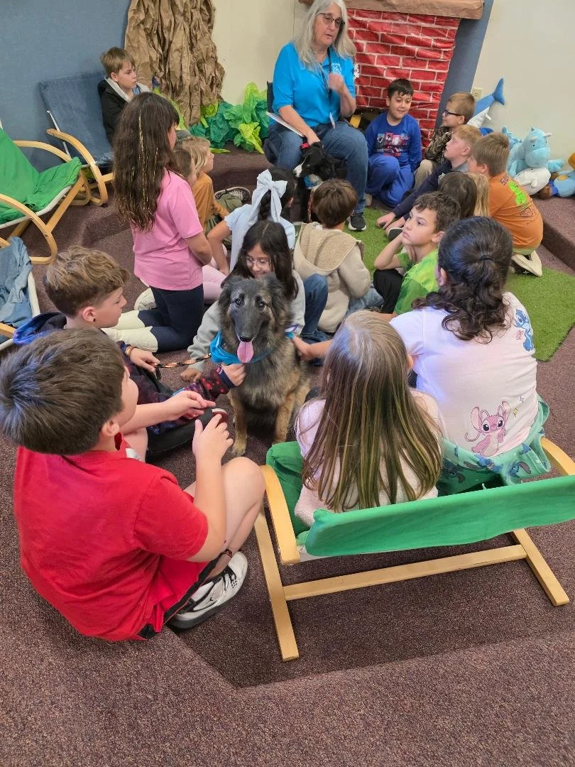 Higgins at library with children.jpg