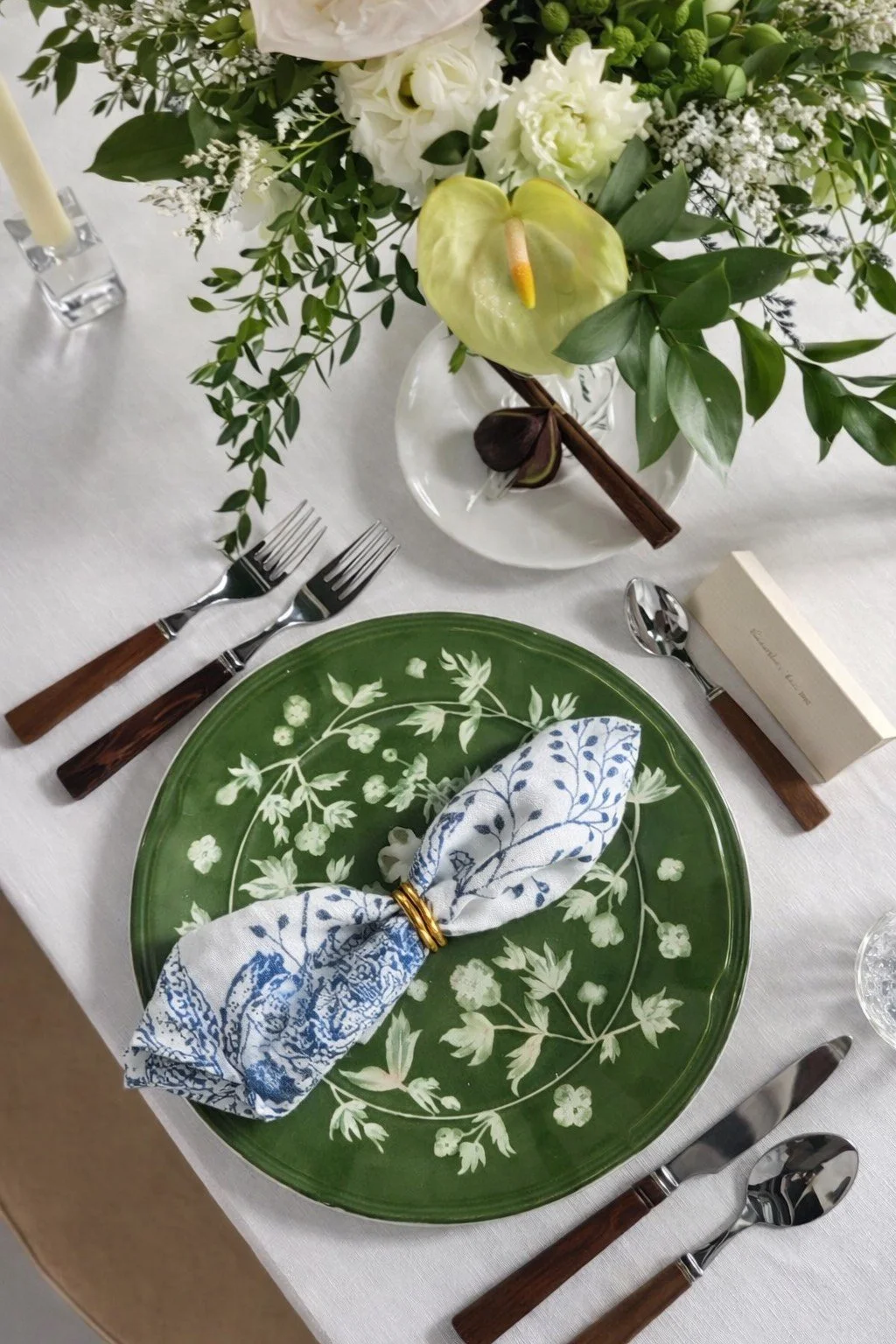 The Giardino Charger Plate features soft green tones and delicate white florals, bringing timeless garden-inspired elegance to any table setting. | Kelowna Pattern Green Charger Plate Rental