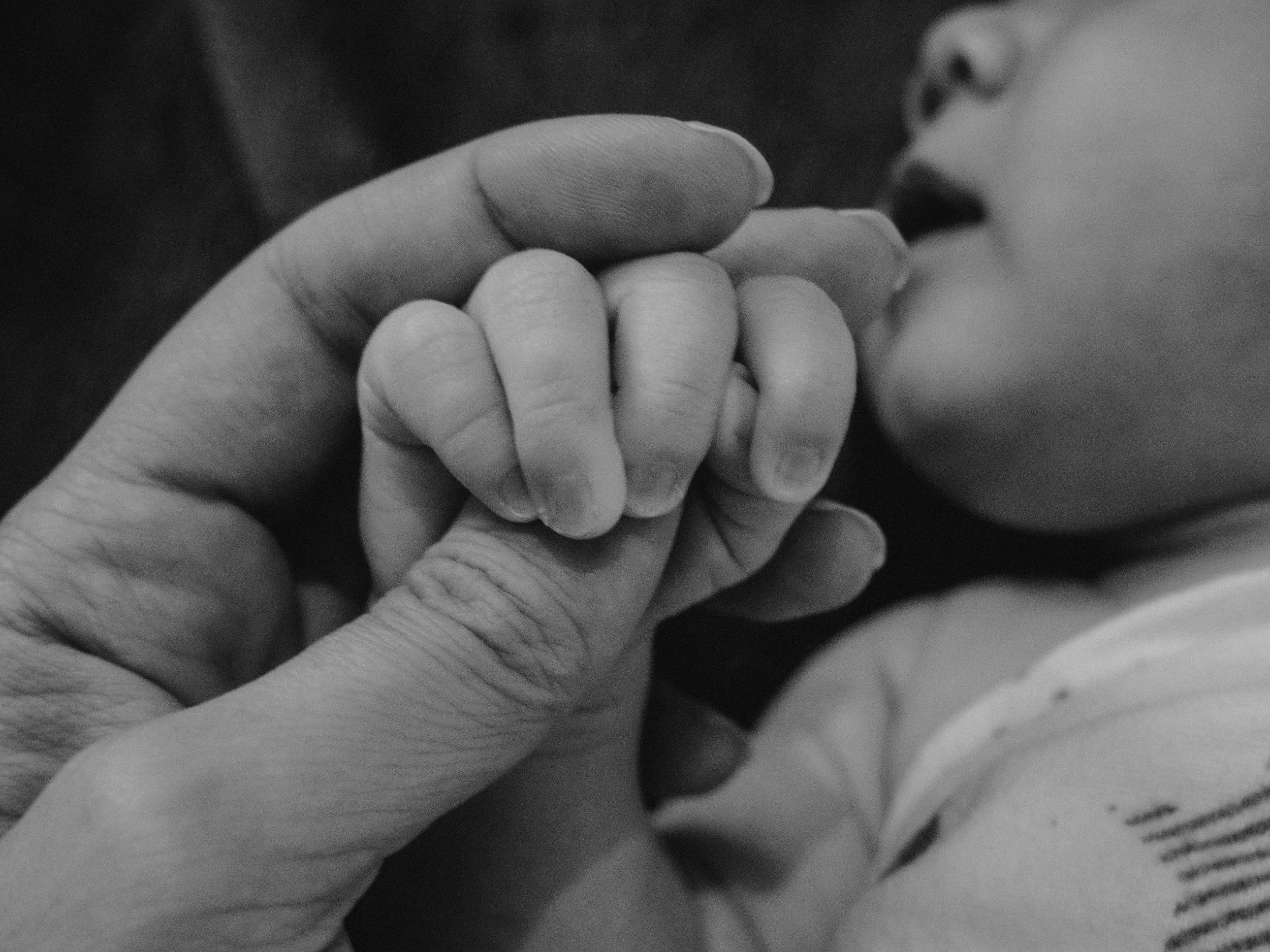 A new born baby gripping their mom's thumb. Learn how to bond with your baby after birth trauma with EMDR therapy in Worthington, OH. Find connection with your baby. Reach out to a trauma therapist in Columbus, OH.
