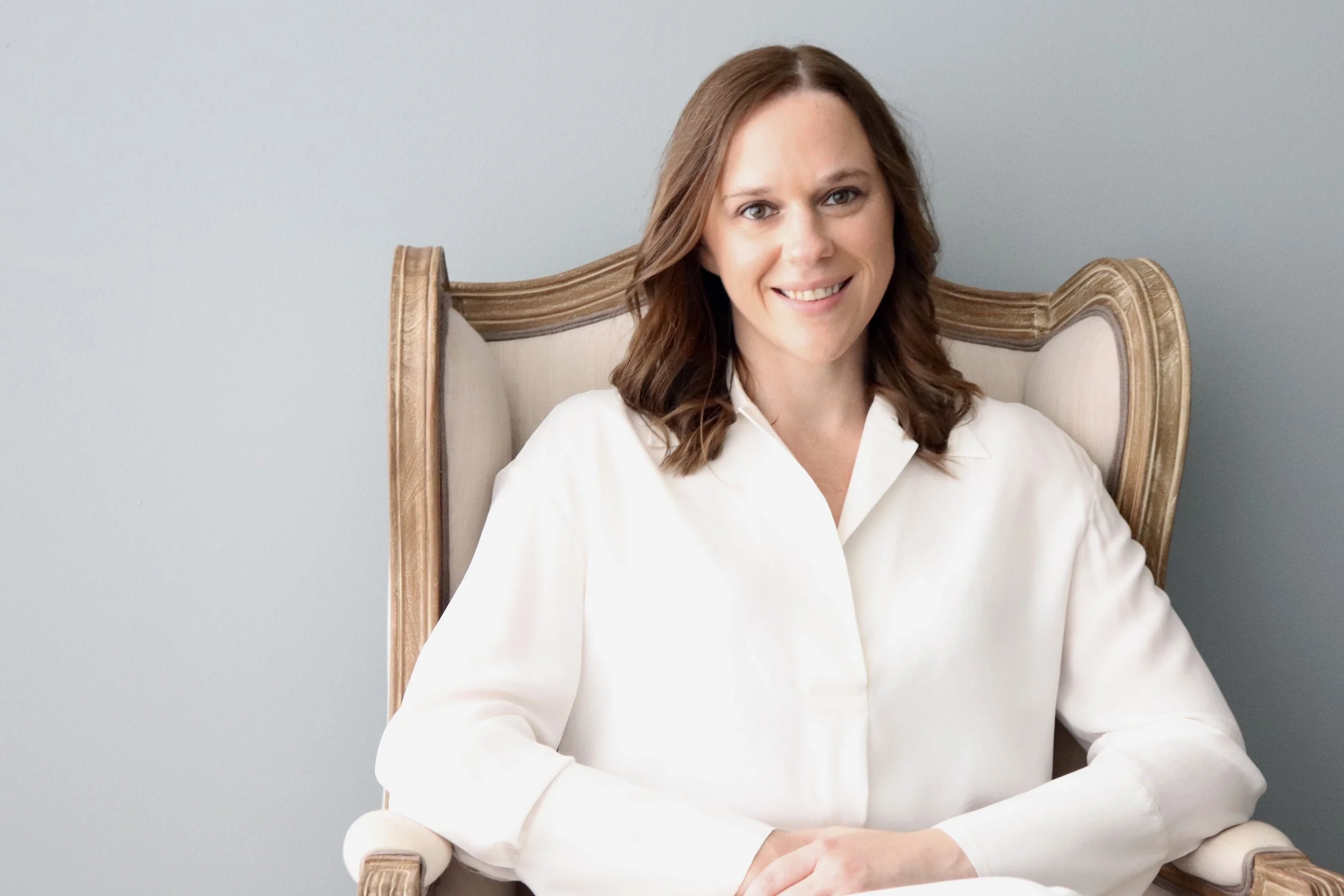 Merrianna Holdeman sitting in a therapist chair smiling. With a trauma informed therapist, you can start feeling relief with Somatic and EMDR therapy. Reach out to an EMDR therapist in Columbus, Ohio. Change is possible.