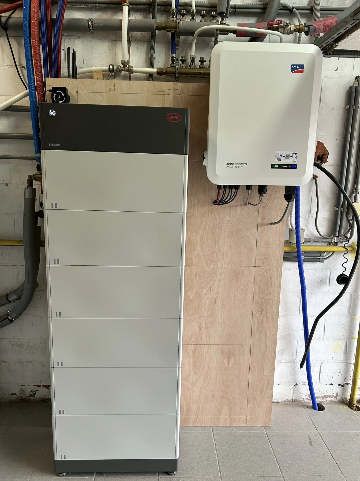 Thuisbatterij van BYD en SMA omvormer op houten wand