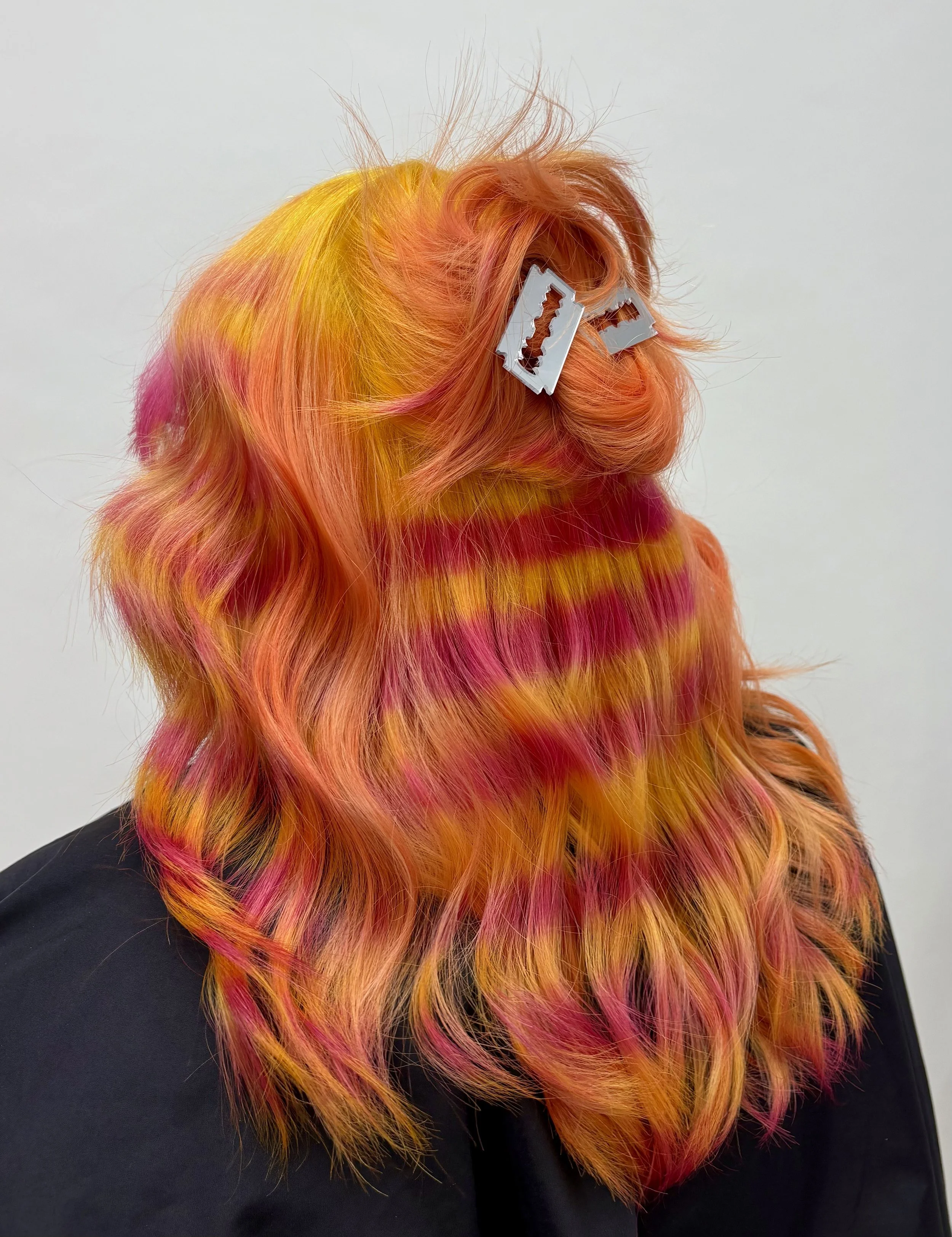 This pink and orange stripe pattern is a perfect example of why Lily is an expert Seattle hair colorist.