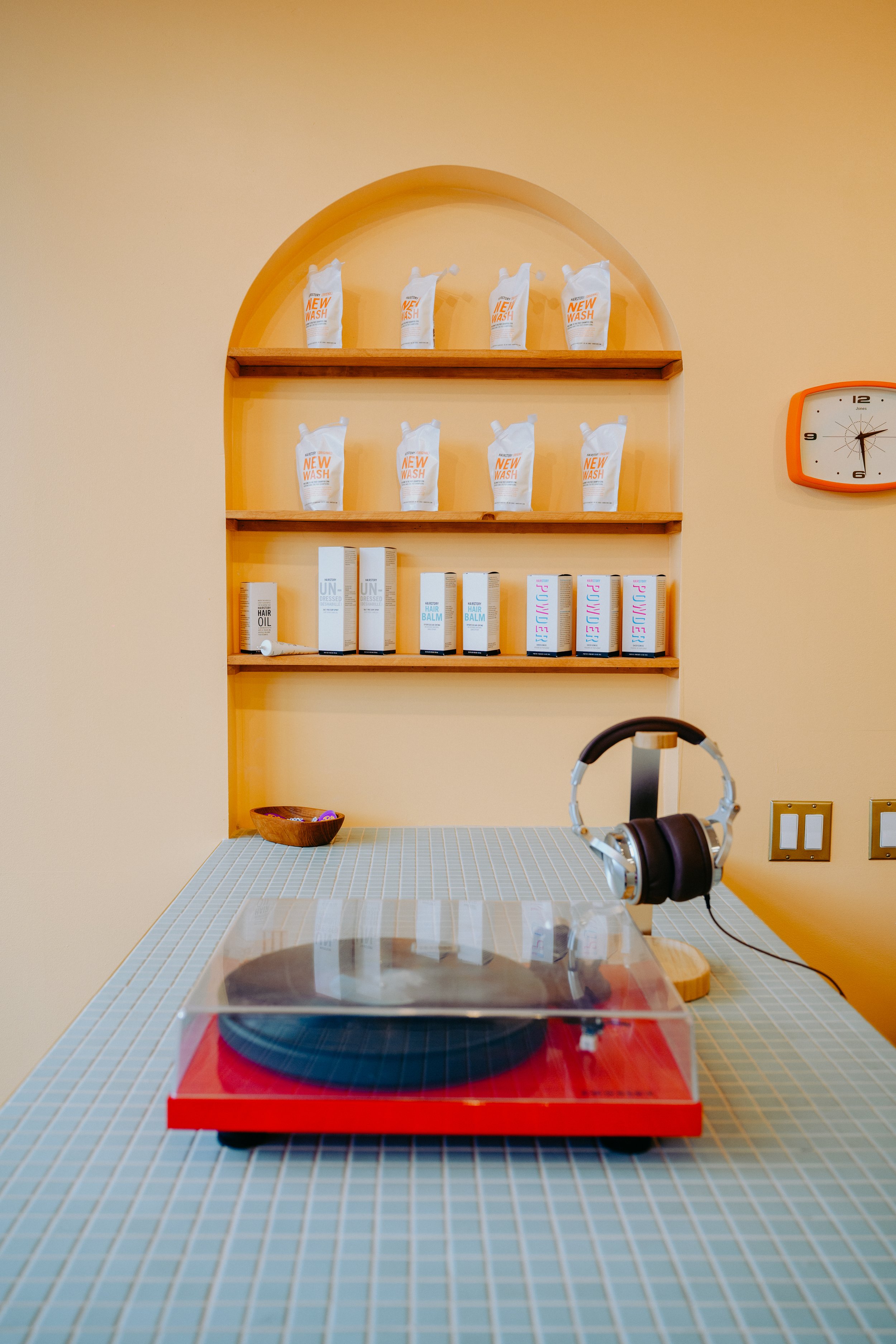 When you walk in the front door the first thing you see is a record player at our front desk. This is an ode to the 60s theme of this hair salon in Seattle.