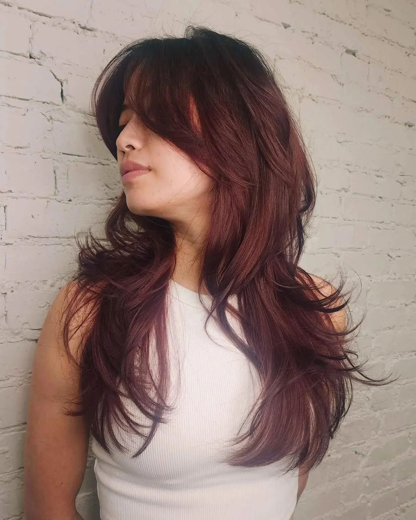 This picture demonstrates Em's range and versatility. This long layered haircut is a a great example of the jaw-dropping trendy looks that Em creates every single day.