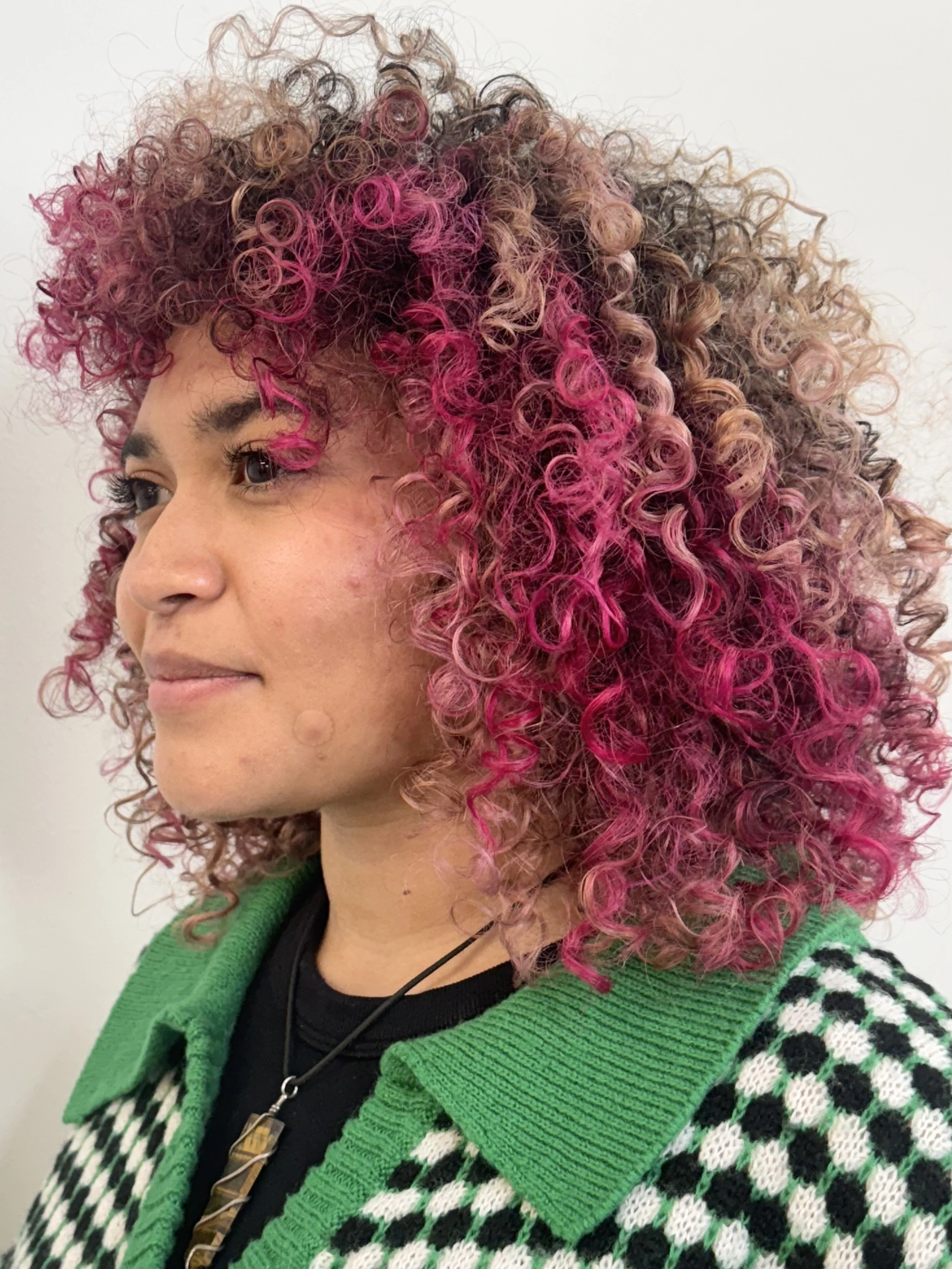 This pink color block on coiled hair further demonstrates Syd's skill as a Seattle hairstylist. All three of these pictures demonstrate different hair textures that are wildly different. All of them are natural and perfectly curated to the client.