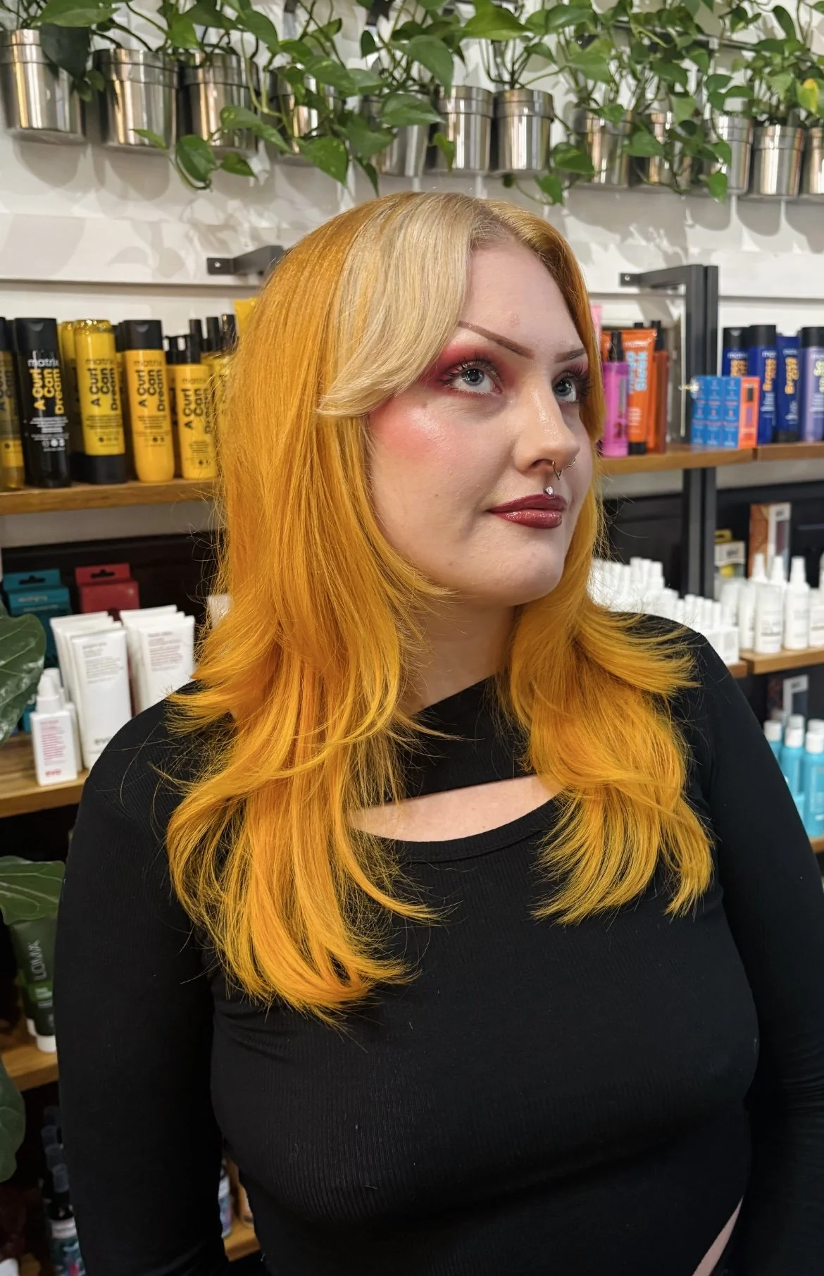 Long layered cut with face-framing layers, bright marigold color and a blonde money piece, one of Meg’s haircuts in the University District at Lady Neptune