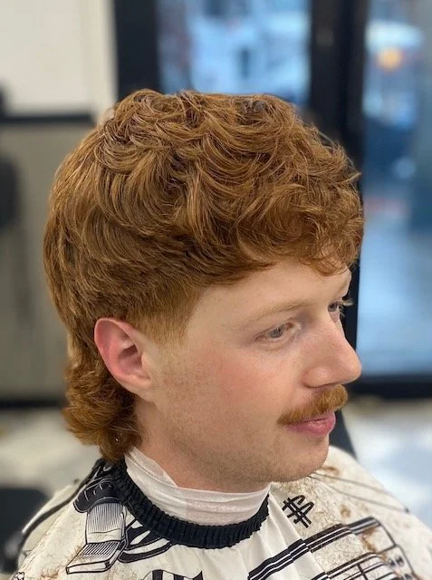This wavy mullet is a perfect examples of the precision barbering haircuts that Zak creates for his clients.